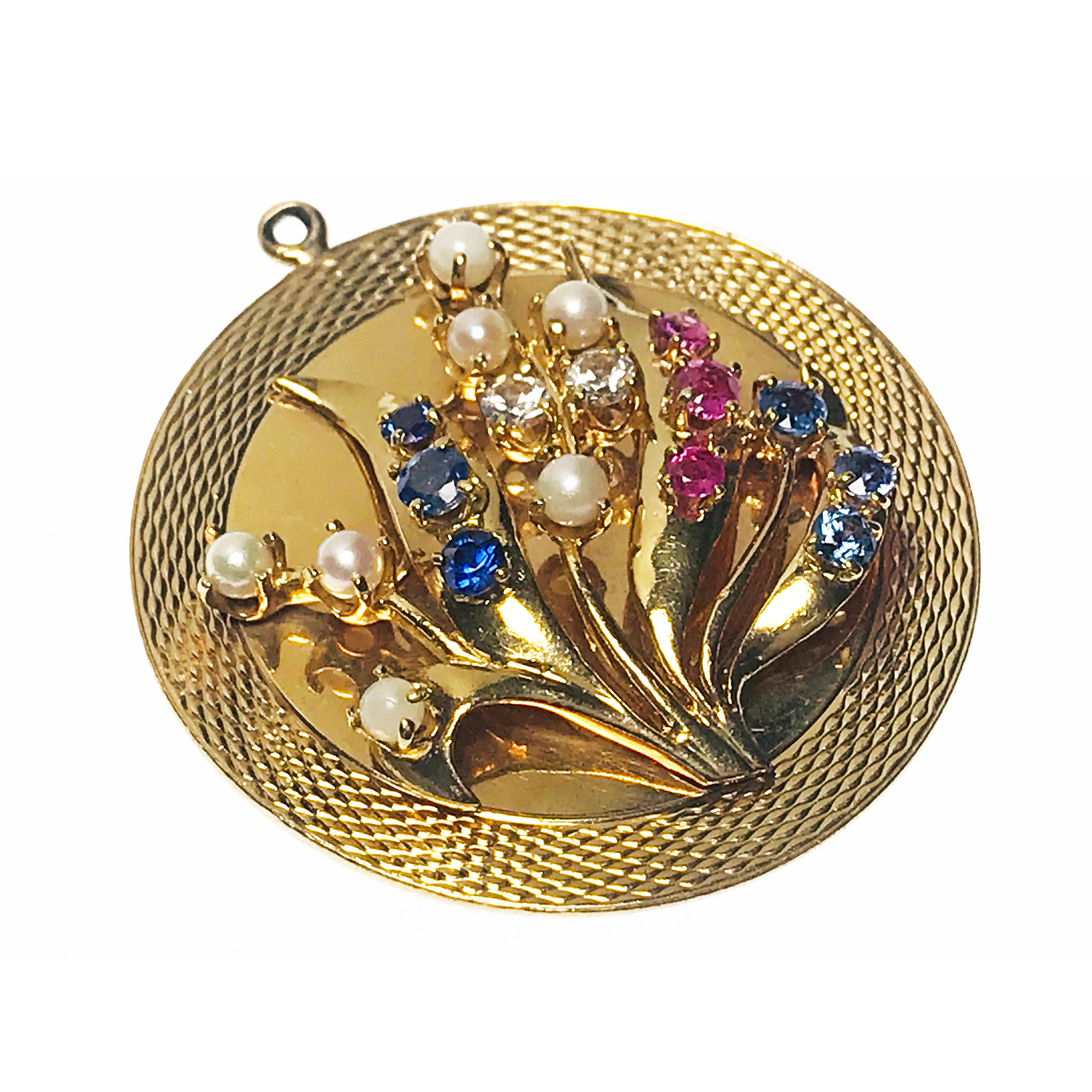Large Multi-Gemstone Pearl Floral Pendant. Large 14k yellow gold pendant with eleven gemstones, seven pearls, all prong set in a floral design of leaves. The seven pearls are 3.5mm, graduate sizes of three Rubies, three blue Sapphires, three blue