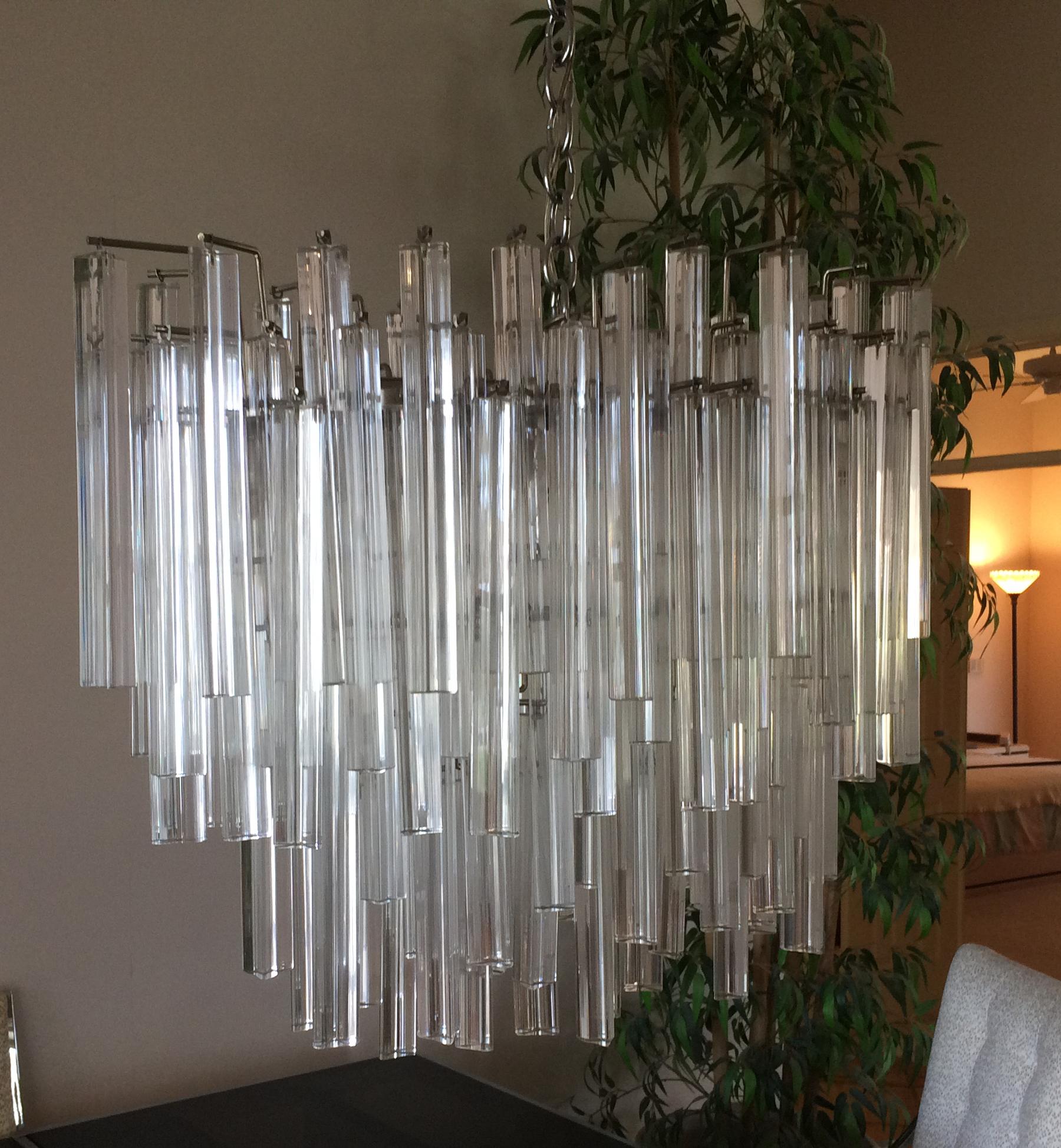Marked Camer Glass made in Italy. Has approximately 121 glass drops. Multiple tiers make for a very substantial chandelier. All in very good condition. Measures: Approximately 32 inches wide x 24 high x 18 deep.