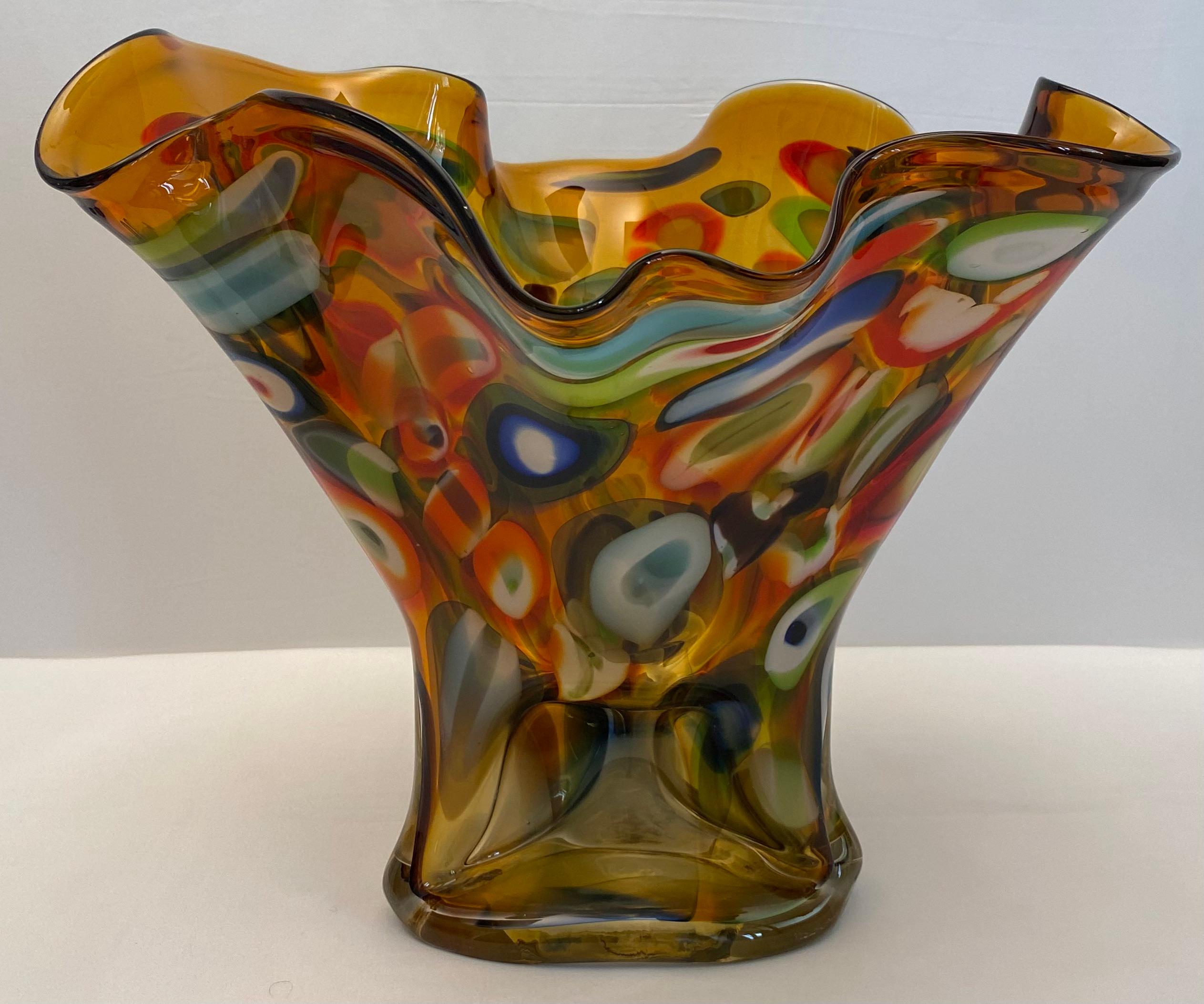 Beautiful and striking, vintage hand blown multi-colored art glass vase or centerpiece.

This gorgeous hand-blown multi-colored art glass vase or centerpiece with its fan shaped rim and ribbons decoration is quite rare. There are large sections of