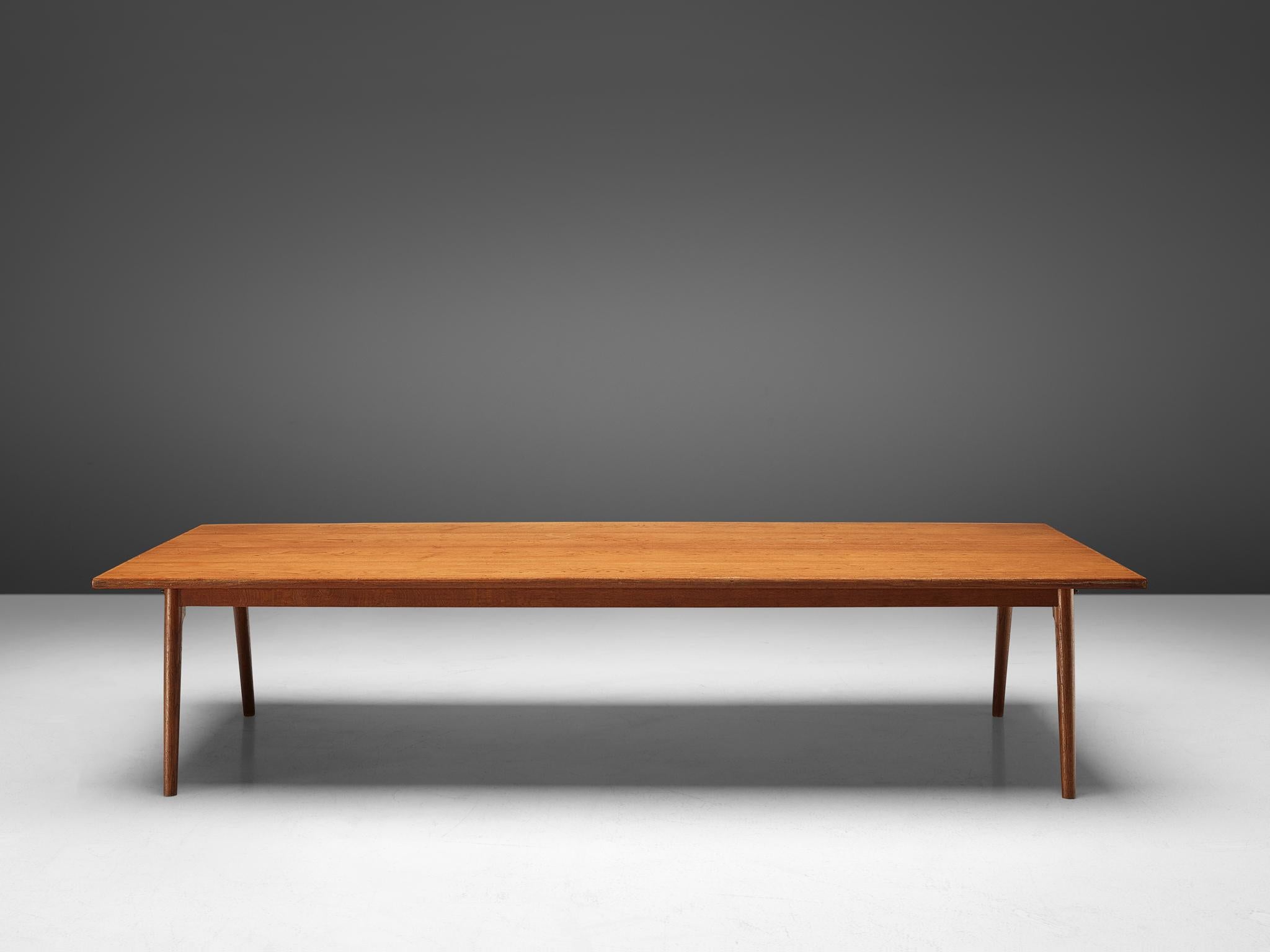 Conference table or dining table, oak, Denmark, 1950s.

Large conference- or dining table in oak. The rectangular shaped tabletop is made out of one piece, featuring a beautiful grain. The base consists of four conical legs and shows beautiful