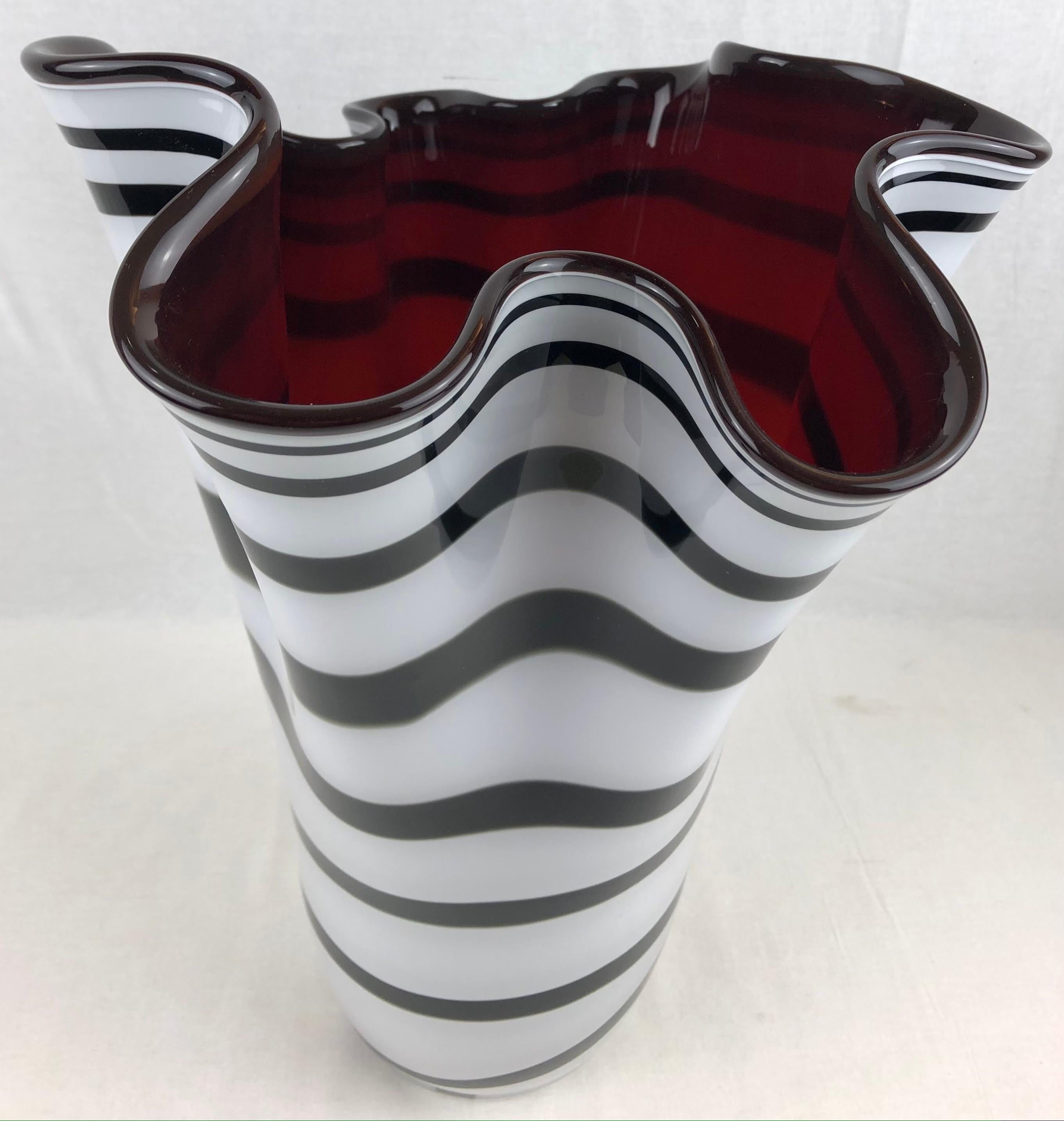 A playful and organically beautiful, mouth blown, art glass vase. This vase is beautiful with or without flowers; perfect as a standalone piece and is substantially sized. 

The glass making technique here is call 'incamicato'; where layers of