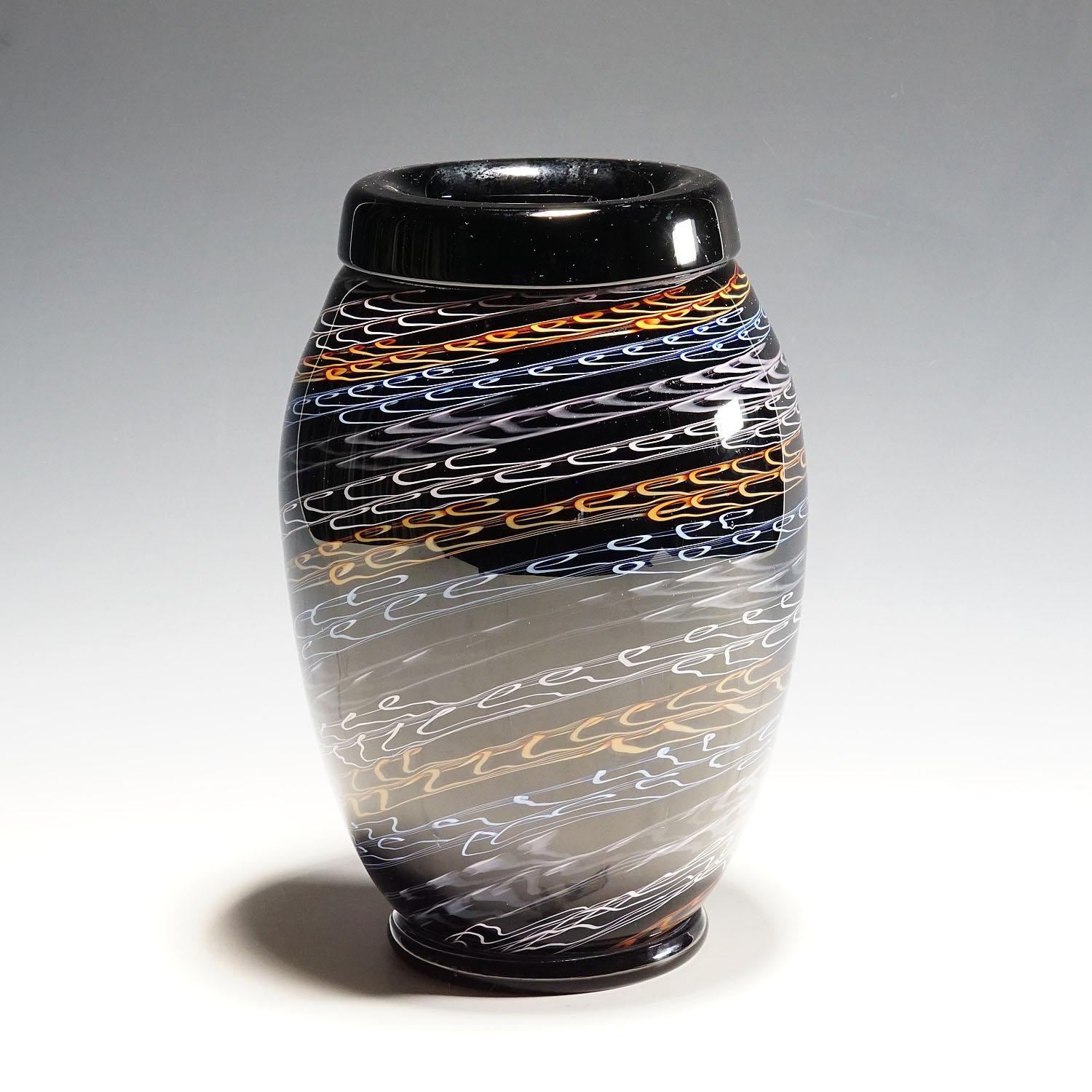 Large Murano Art glass vase by Master Paolo Crepax 1990s.

A large Murano Art Glass Vase by designed and executed by Glassmaster Paolo Crepax in the 1990s. Thick black glass with ondulating decoration in blue white and orange and covered with a