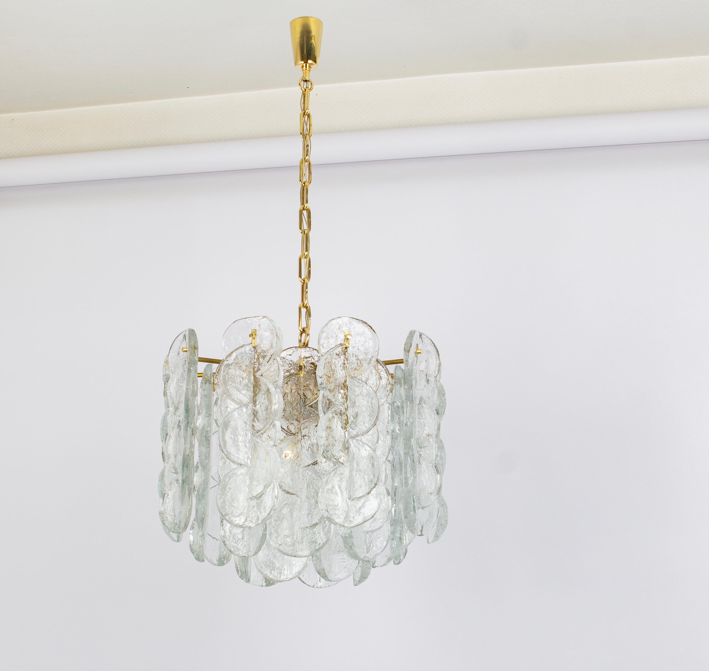 Wonderful Murano glass chandelier by Kalmar, 1970s
Swirl ice glass, clear twisted crystal glass panels on a gold color frame with a brass chain and canopy.
Measures: diameter 19.7