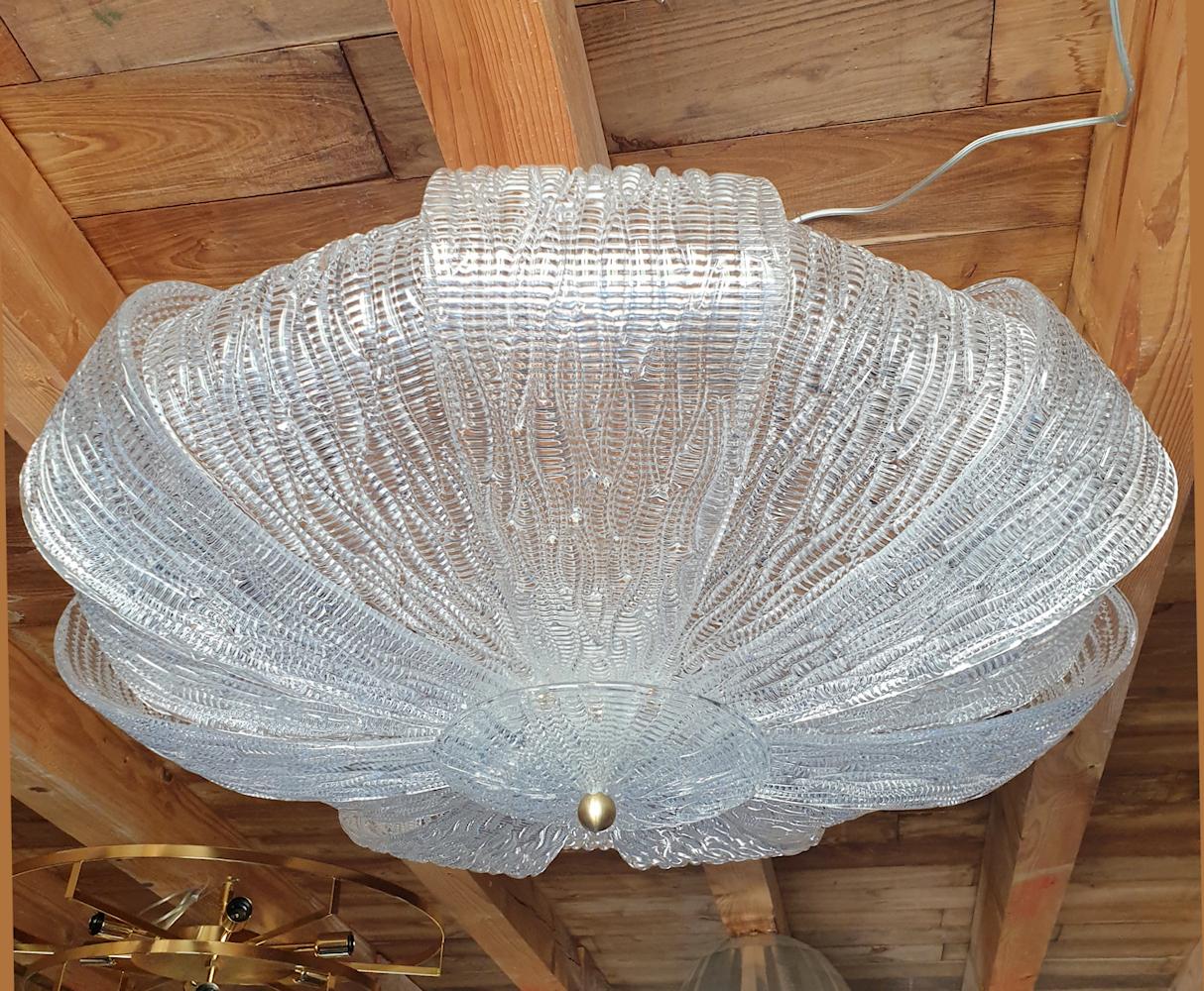 Very large Murano clear and textured glass flush mount chandelier, Mid-Century Modern, Barovier style, Italy, 1970s.
The vintage Murano chandelier has 8 lights, and has been rewired with medium base sockets, or E26.
A chain can be added, to hang