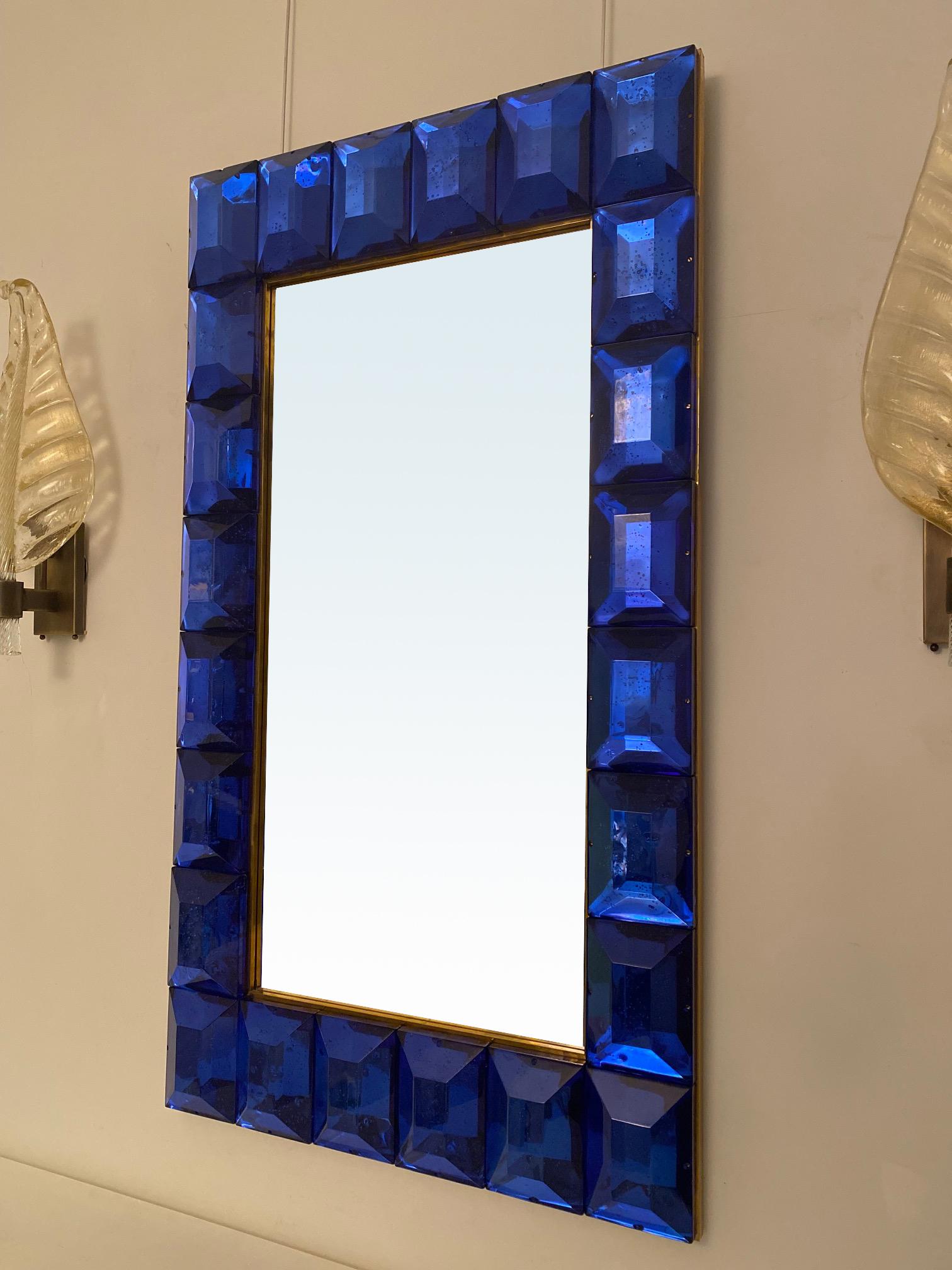 Large cobalt blue diamond cut murano glass mirror.
Vivid and intense cobalt blue glass block with naturally occurring air inclusions throughout
Highly polished faceted pattern
Brass gallery
Luxury handcrafted by a team of artisans in Venice,