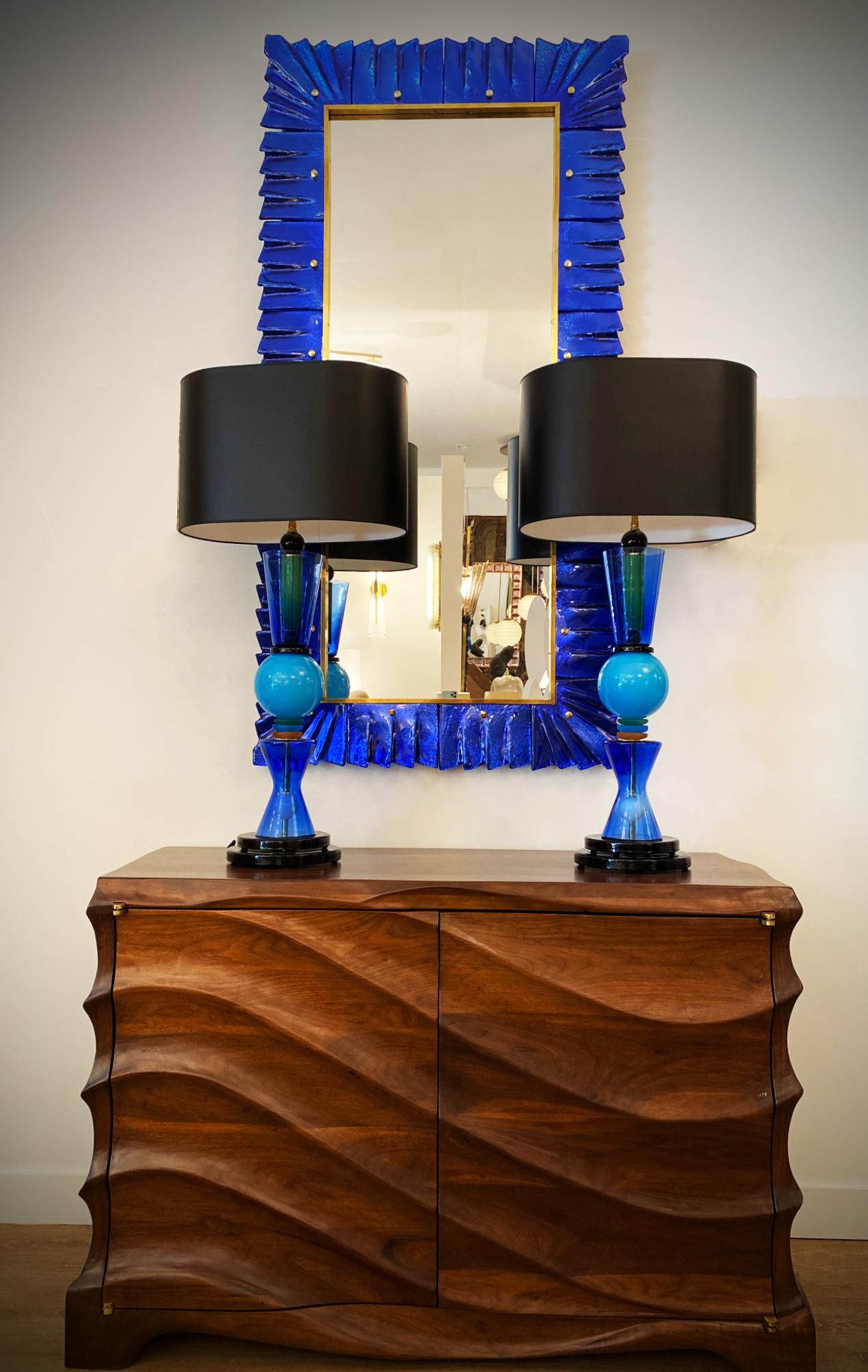 Large Murano cobalt blue glass mirror, in stock
Solid brass cabochon accents.
Glass texture and color are absolutely striking.
Brass surrounding gallery
Can be hung vertical or horizontal.
Pair available now
Priced individually
Located in our