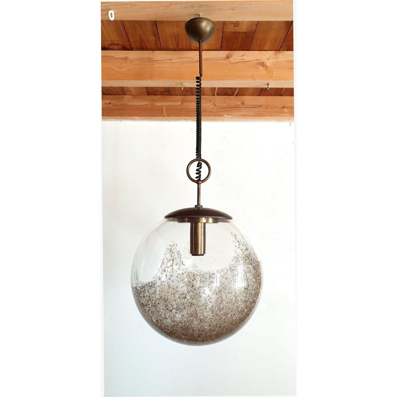 Large Murano glass globe pendant light, by Carlo Nason for Mazzega, Murano, Italy, 1960s.
The Mid Century Modern pendant is made of a Murano glass transparent globe, with a brown irregular decor,
inside the ball, that creates a translucent effect