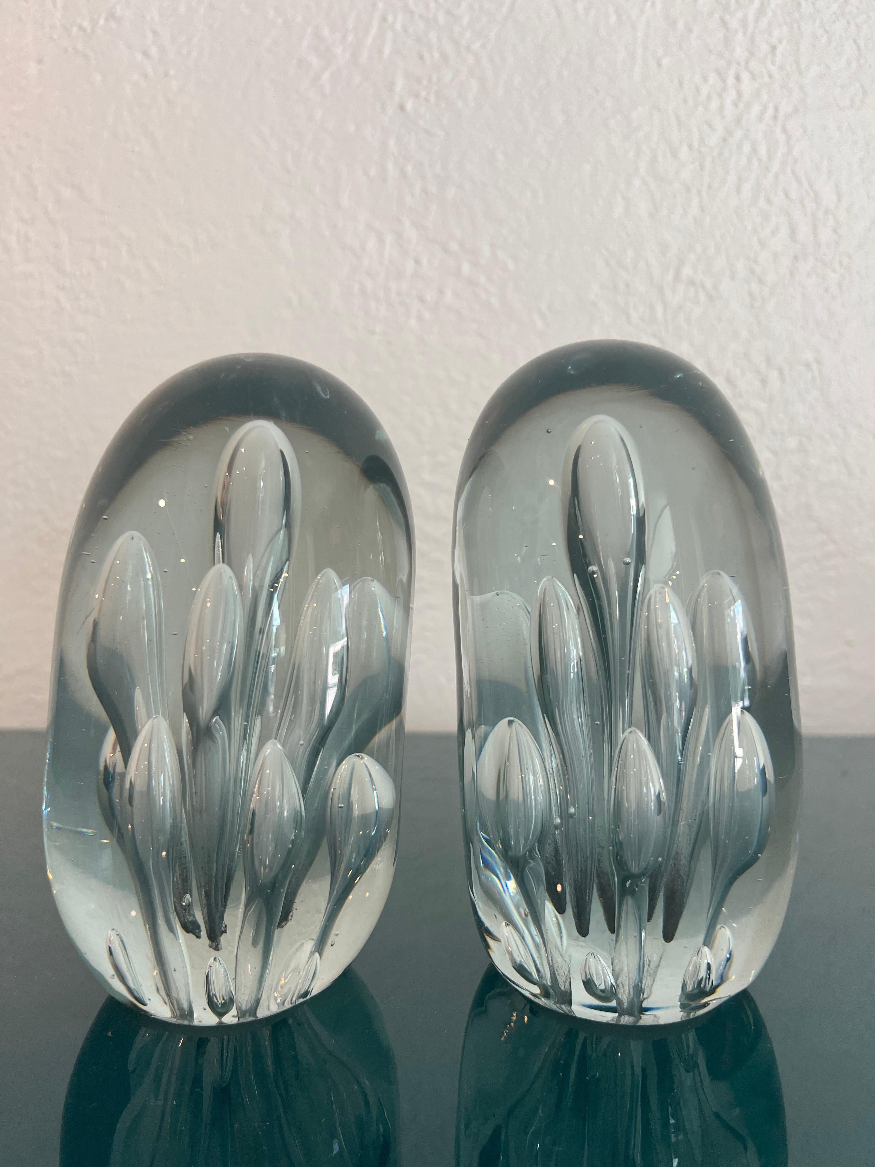 Pair of large Murano glass bookends. Beautiful controlled bubble inclusions. 

Would work well in a variety of interiors such as modern, mid century modern, Hollywood regency, etc. Piece blends seamlessly with other designers such as Warren Platner,