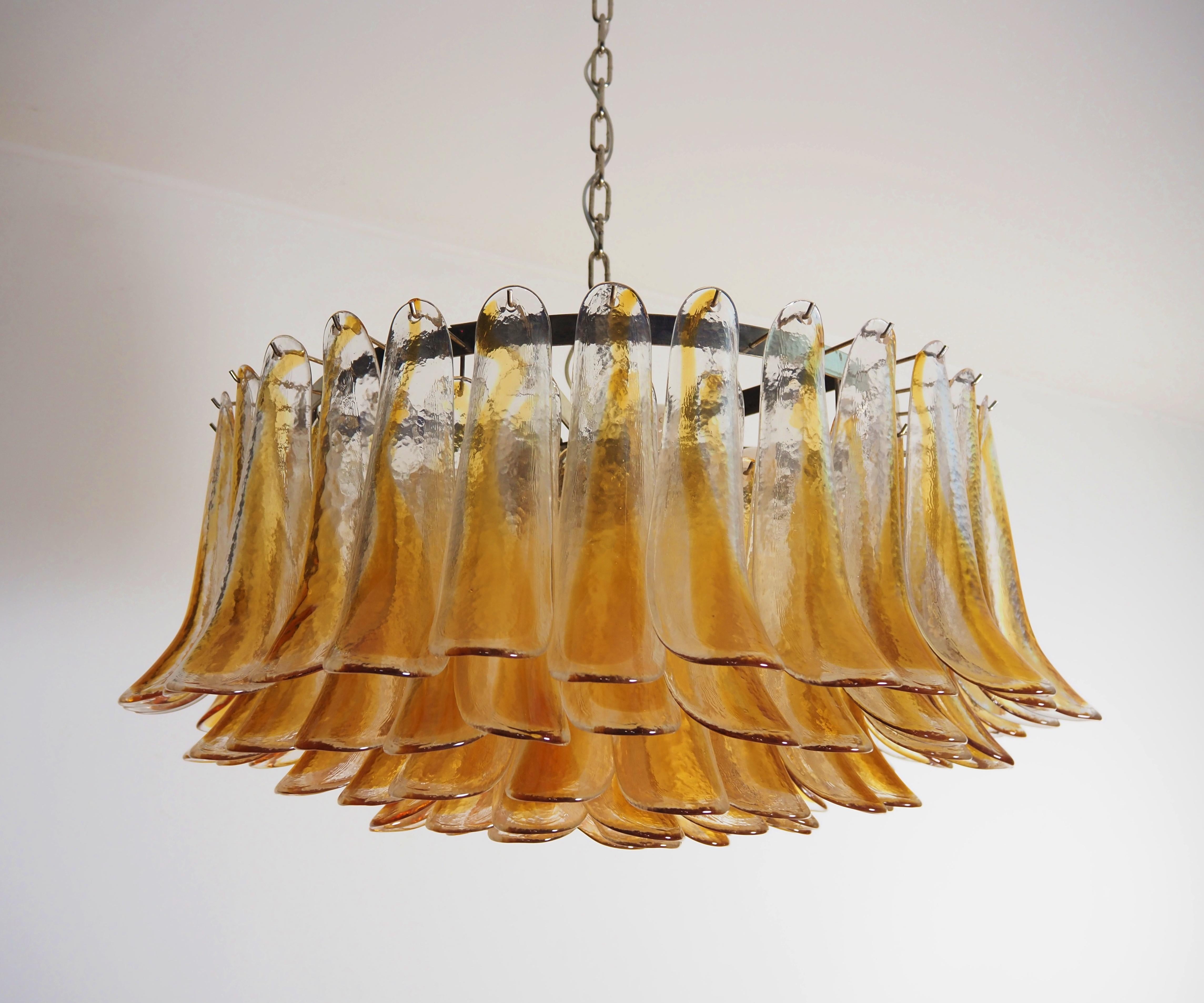 Italian vintage chandelier in Murano glass and nickel plated metal structure. The armor polished nickel supports 101 glass petals (clear and amber)  that give a very elegant look. Can be used as a chandelier with chain, or as a ceiling light, the