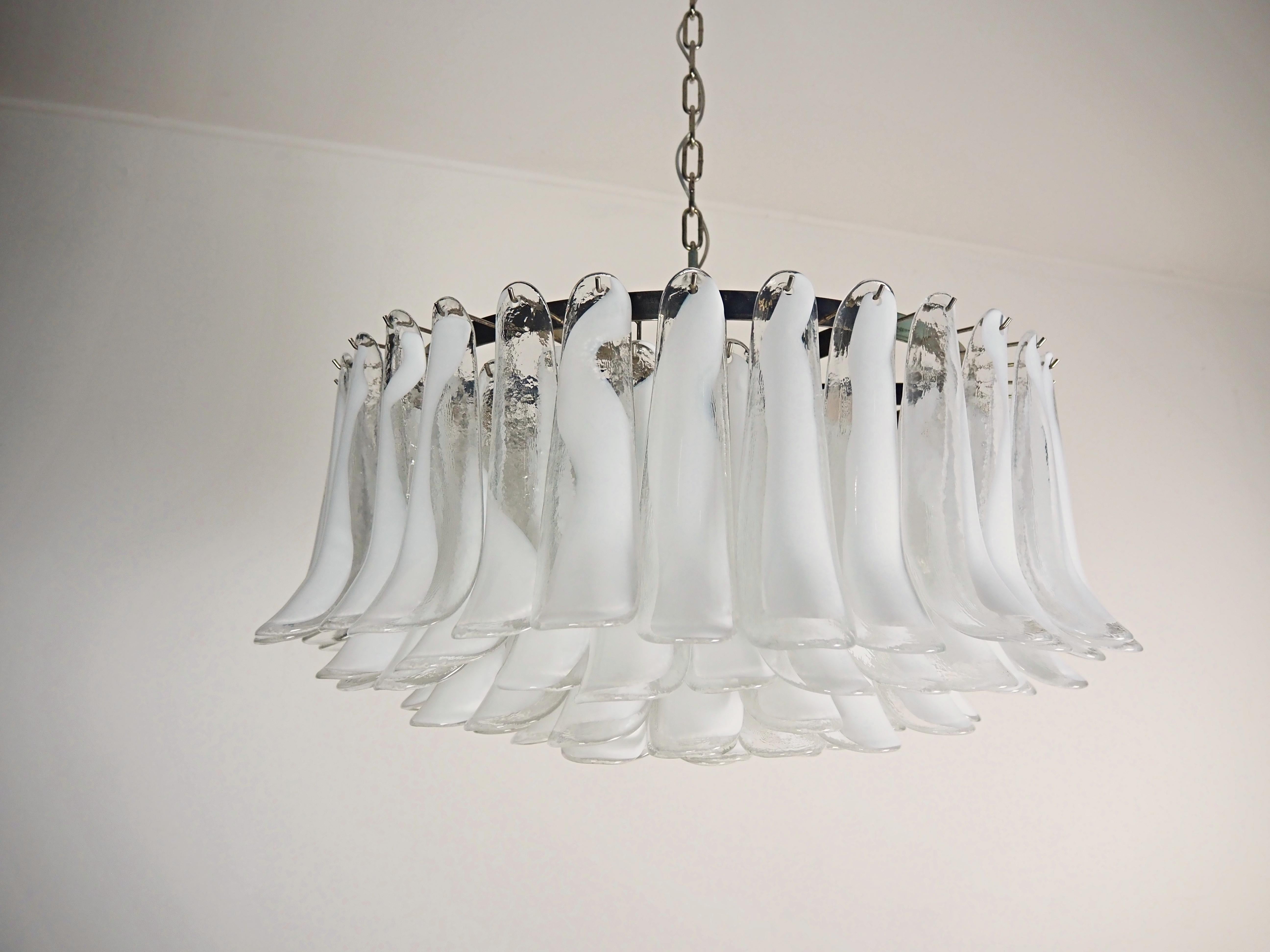 
Italian vintage chandelier in Murano glass and nickel plated metal structure. The armor polished nickel supports 101 white lattimo Murano glass petals. Can be used as a chandelier with chain, or as a ceiling light, the structure will be hung