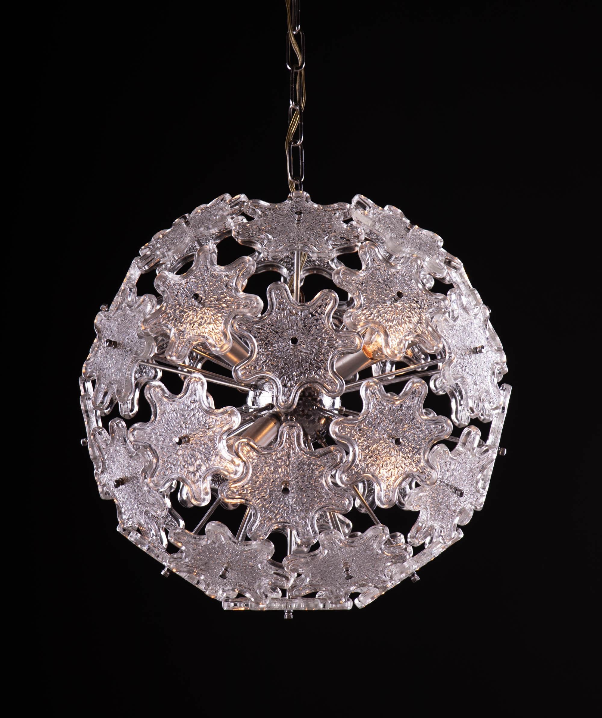 Elegant starburst pendant lamp designed by Paolo Venini. Chromed stems and hardware and steel fixture. Newly rewired with six sockets. Star-shaped Murano glass resembles flowers. Chandelier illuminates beautifully and offers a lot of light.