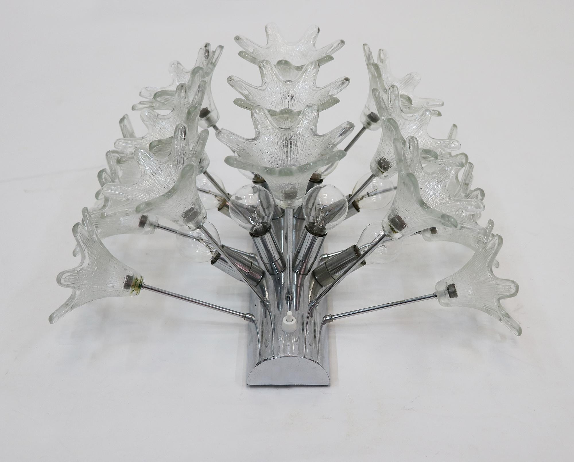 Large Murano glass wall sconce by Paolo Venini for VeArt, Italy with 15 clear glass flowers on a Sputnik chrome frame.
Amazing eye-catching pieces designed in the 1960s, Italy.

Measures: width 18.5“ in. (47 cm), height 15.35“ in. (39 cm).