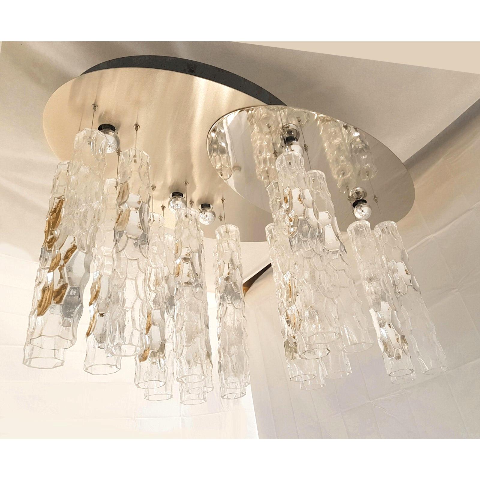 Unusual large Mid Century Modern flush mount chandelier, with Murano Bamboo glass pendants, by AV Mazzega, 1970s. The ceiling plate is composed of 2 ovals: in mirrored chrome, and brushed steel. 
Murano clear glass bamboo tubes, with a silver ring