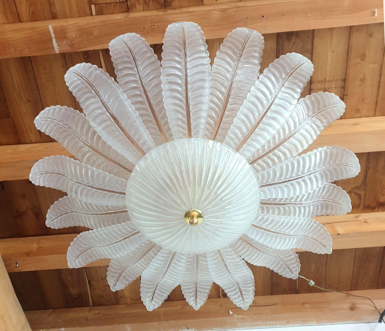 Extra large Leaf Murano glass Mid Century Modern flush-mount chandelier, by Barovier and Toso, Italy 1980s.
The Vintage Chandelier is made of large frosted Murano glass leaves and a center bowl, on a white painted frame.
With brass elements: finial
