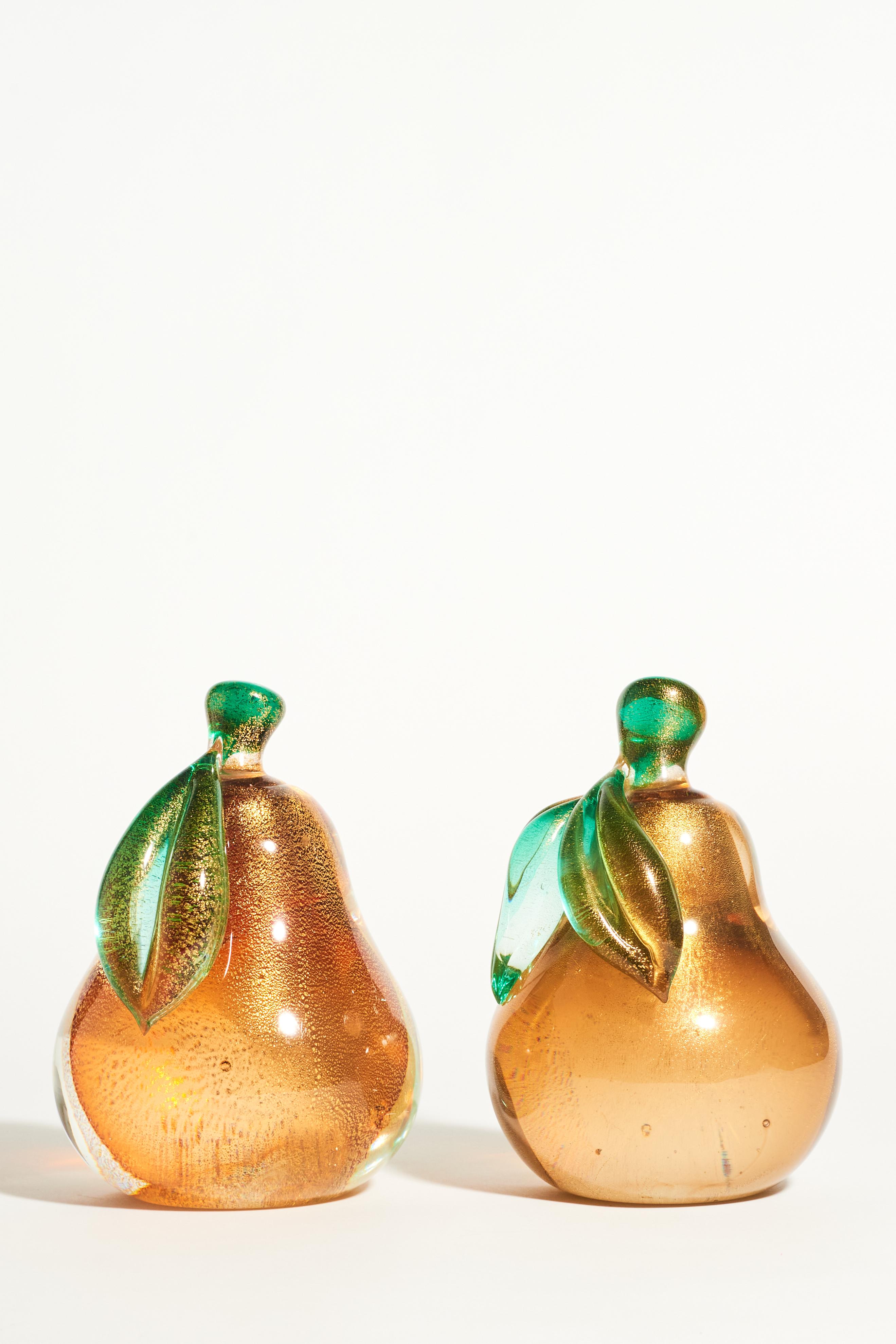 Large Murano glass bookends with deep golden amber and gold flecked interior green and gold flecked stems and leaves.
 