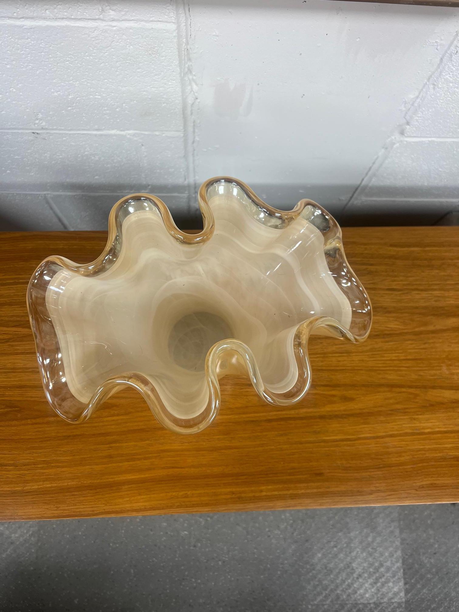 Beautiful Murano ruffled glass vase. Swirling pattern. Estimated to be from the year 2000. Fairly new, not vintage. No label but identical ones are frequently seen with a Murano label.
Stands 12