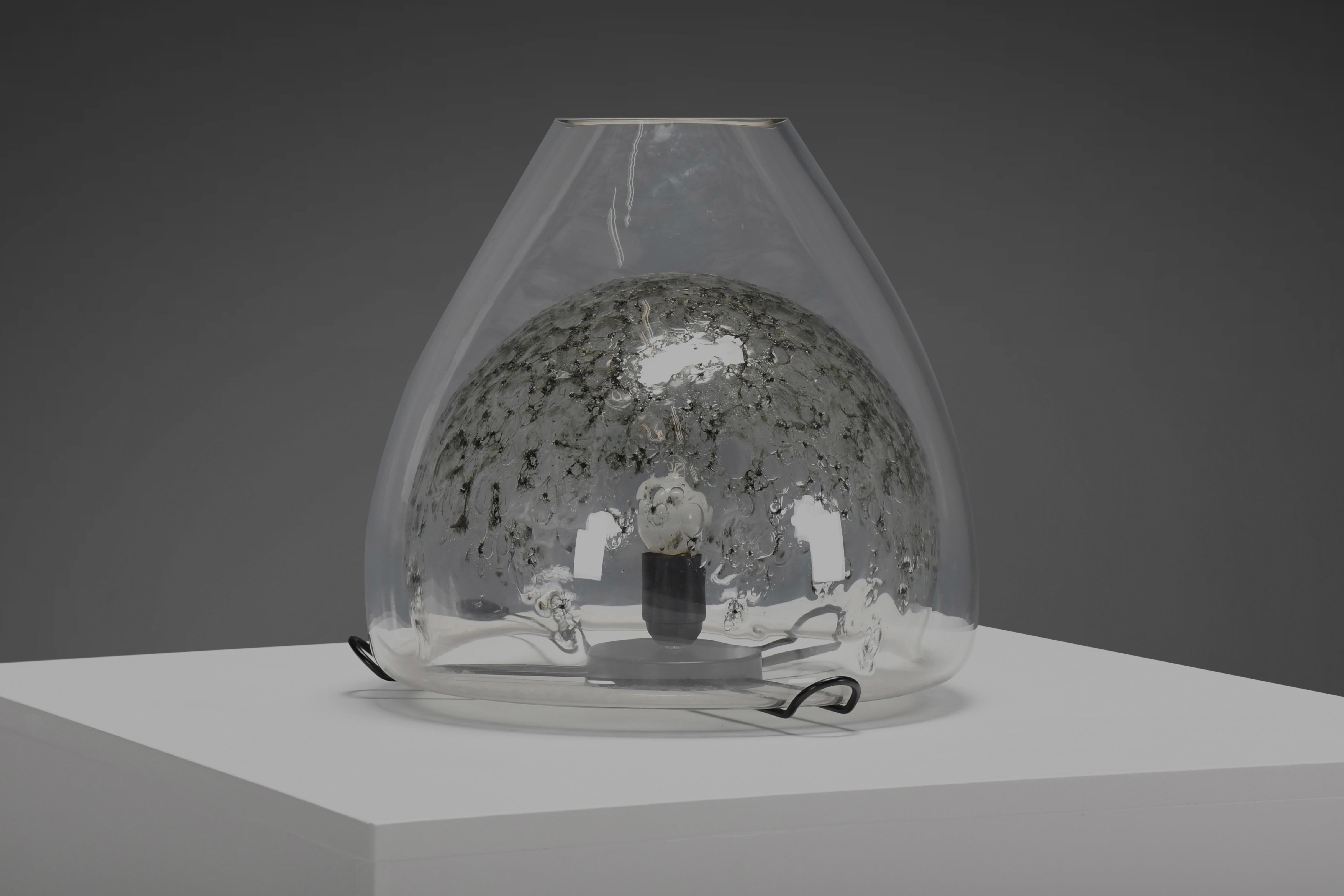 Impressive Murano glass table lamp in excellent condition.

This beautiful cone shaped table lamp is realized by the prestigious Murano glass company ‘La Murrina’ in the 1970s.

The handblown glass is transparent on the outside and has grey and