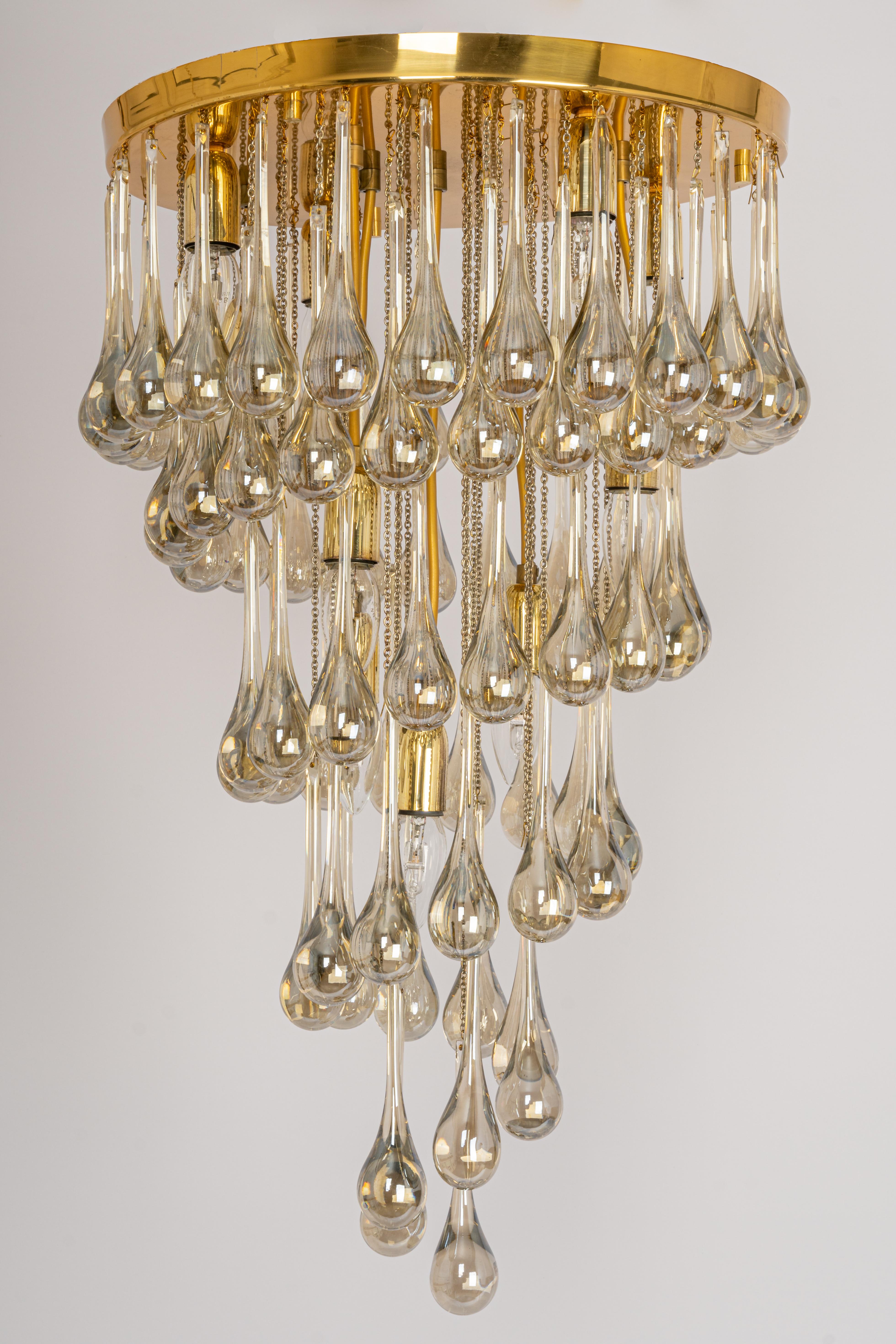 Stunning chandelier by Christoph Palme, Germany, manufactured in the 1970s. It’s composed of Murano teardrop glass pieces on a brass frame.

High quality and in a good condition. Cleaned, well-wired, and ready to use. 
There are 3 small tiny