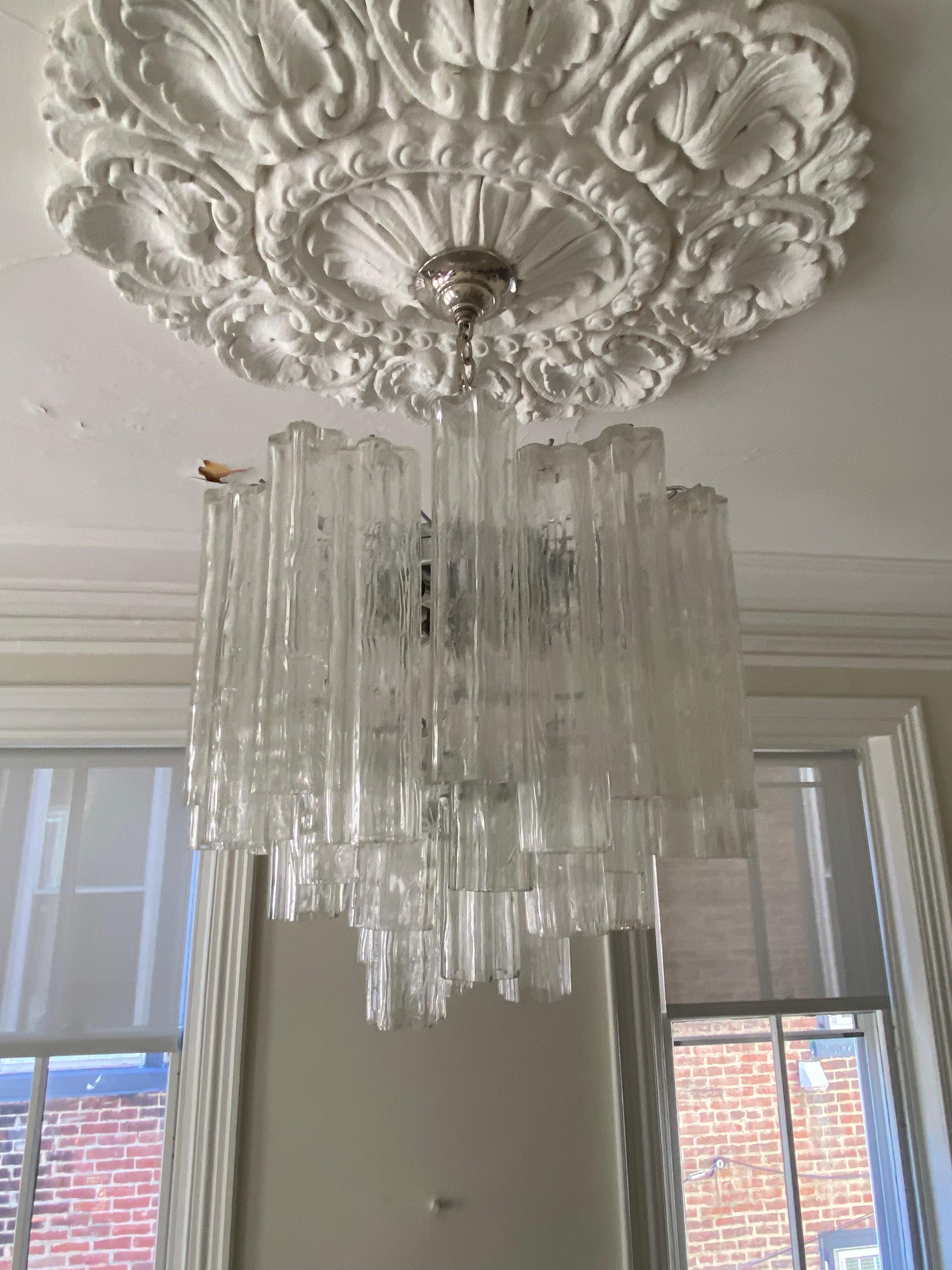 1960s tiered chandelier densely packed with tronchi-shaped murano crystals. Chrome frame holds 22 12