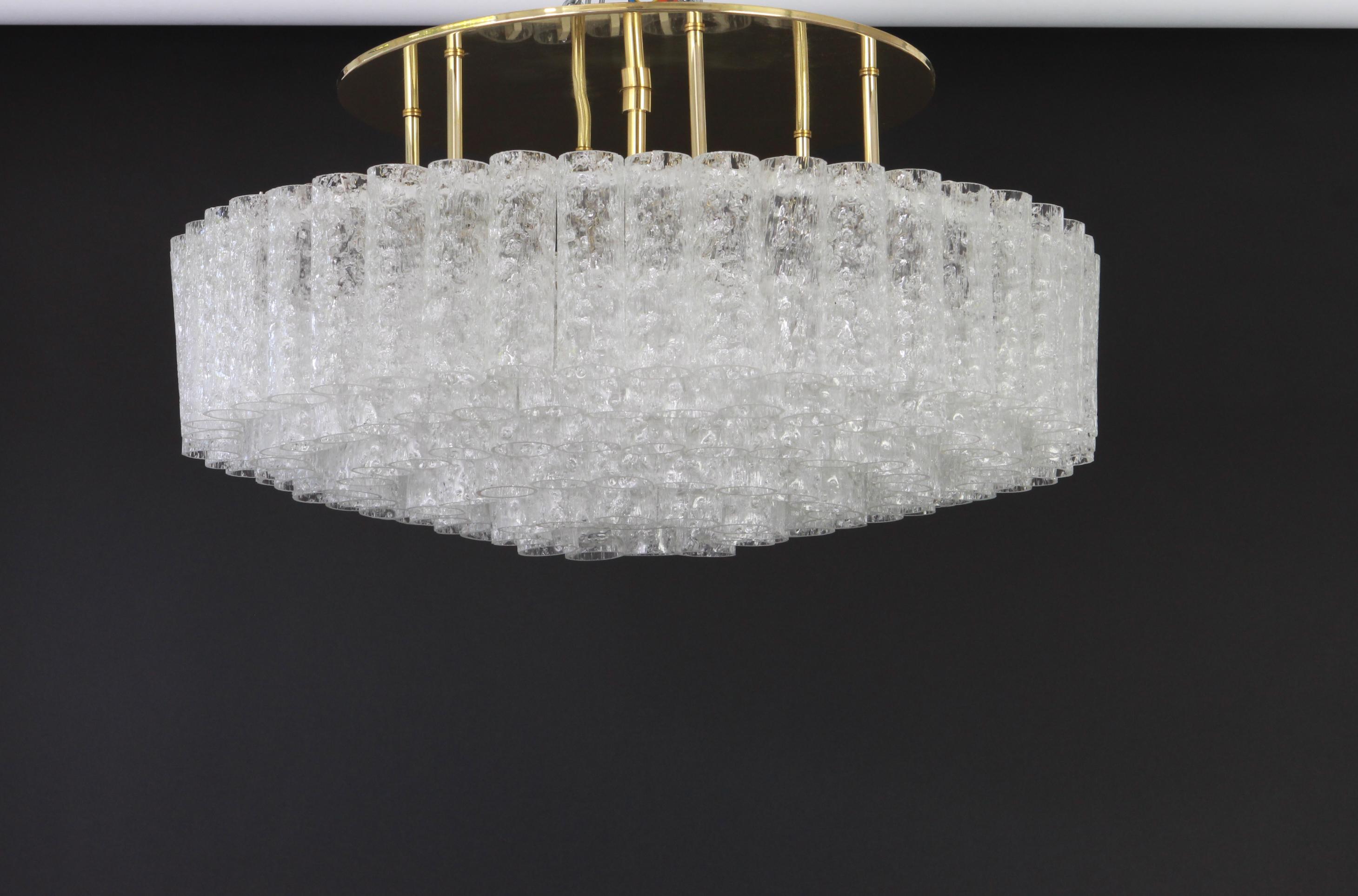 Fantastic five-tier midcentury chandelier by Doria, Germany, manufactured circa 1960-1969. Five rings of Murano glass cylinders suspended from a fixture.

Sockets: 12 x E14 candelabra bulbs //Max.40 watt each + 1 x E27 standard Bulb ( 60