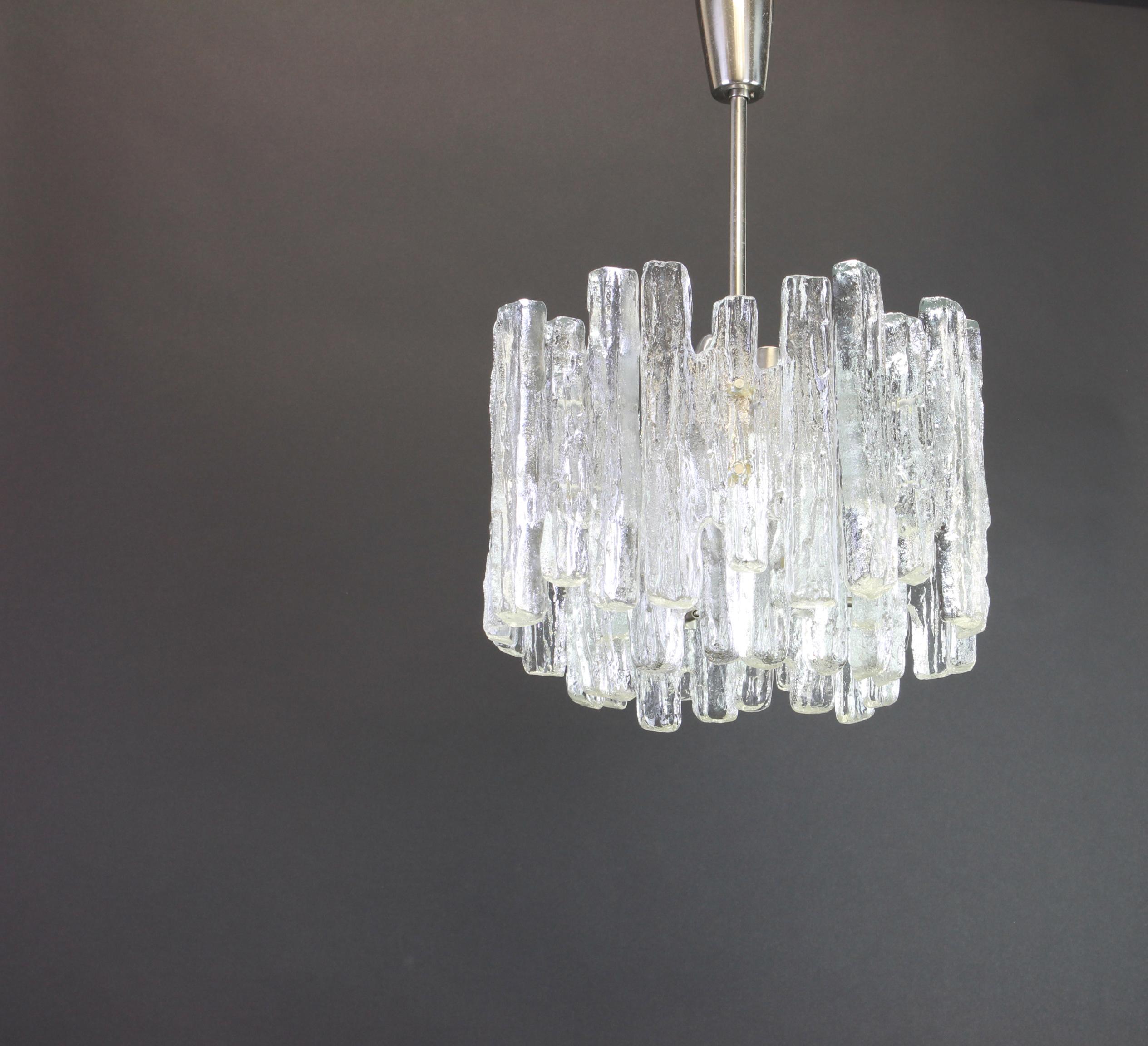 Stunning Murano glass chandelier by Kalmar, 1960s
Three tiers structure gathering 28 structured glasses, beautifully refracting the light very heavy quality.

High quality and in very good condition. Cleaned, well-wired and ready to use. 

The