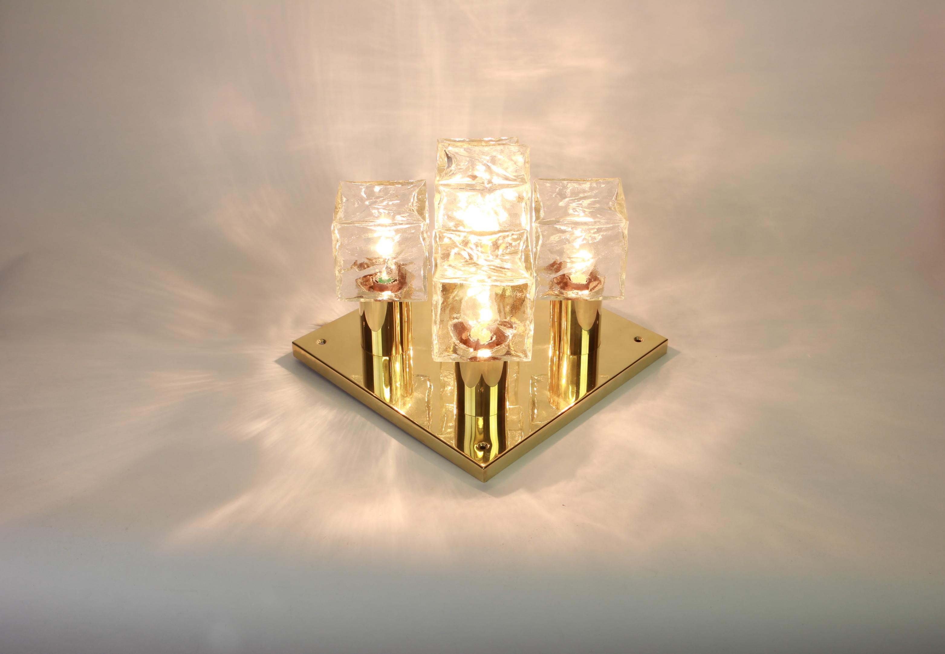 A stunning large flush mount by Kalmar, Austria, manufactured in the 1960s.
The flush mount is composed of a 5 thick textured ice glass elements attached to a brass metal frame.
Wonderful lights effect.

Heavy quality and in very good condition.