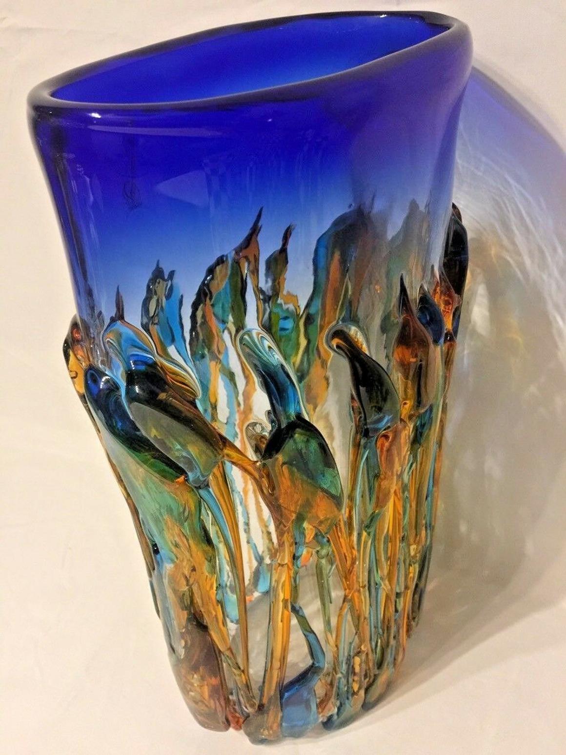 Beautifully designed large Murano Oceanos Vetro Artistico art glass vase with striking colors featuring glowing threads of blue, green, and amber glass, signed and numbered, measuring approximately 14.38 inches tall x 8.5 inches wide top quality