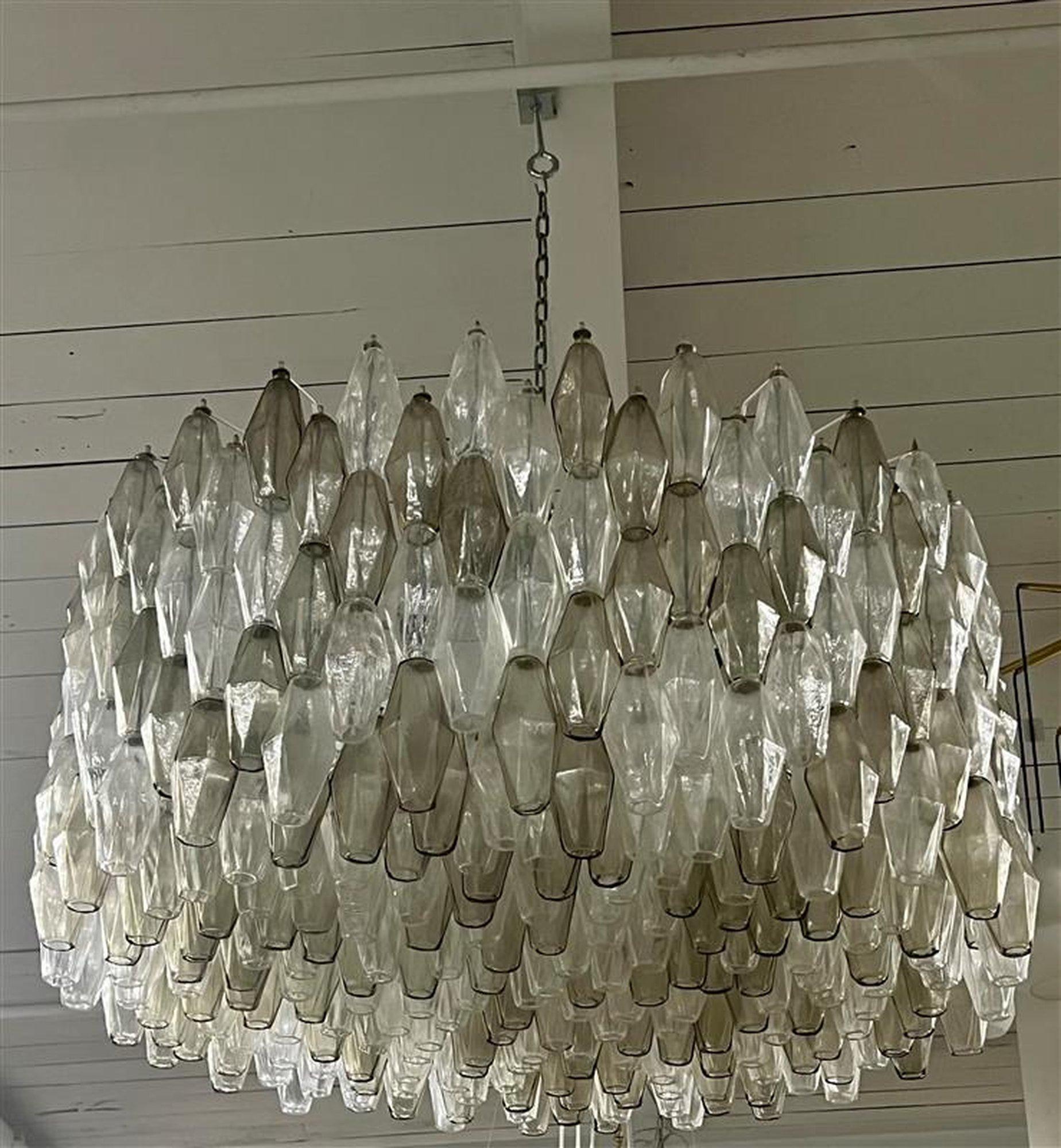 Big Magnificent iconic Mid-Century, Murano glass chandeliers features 462 hand blown Murano polyhedral glass shades in a beautiful array of smoked gray, and clear glass. 
Excellent condition 
The height can be adjusted to suit.
12 light sockets 