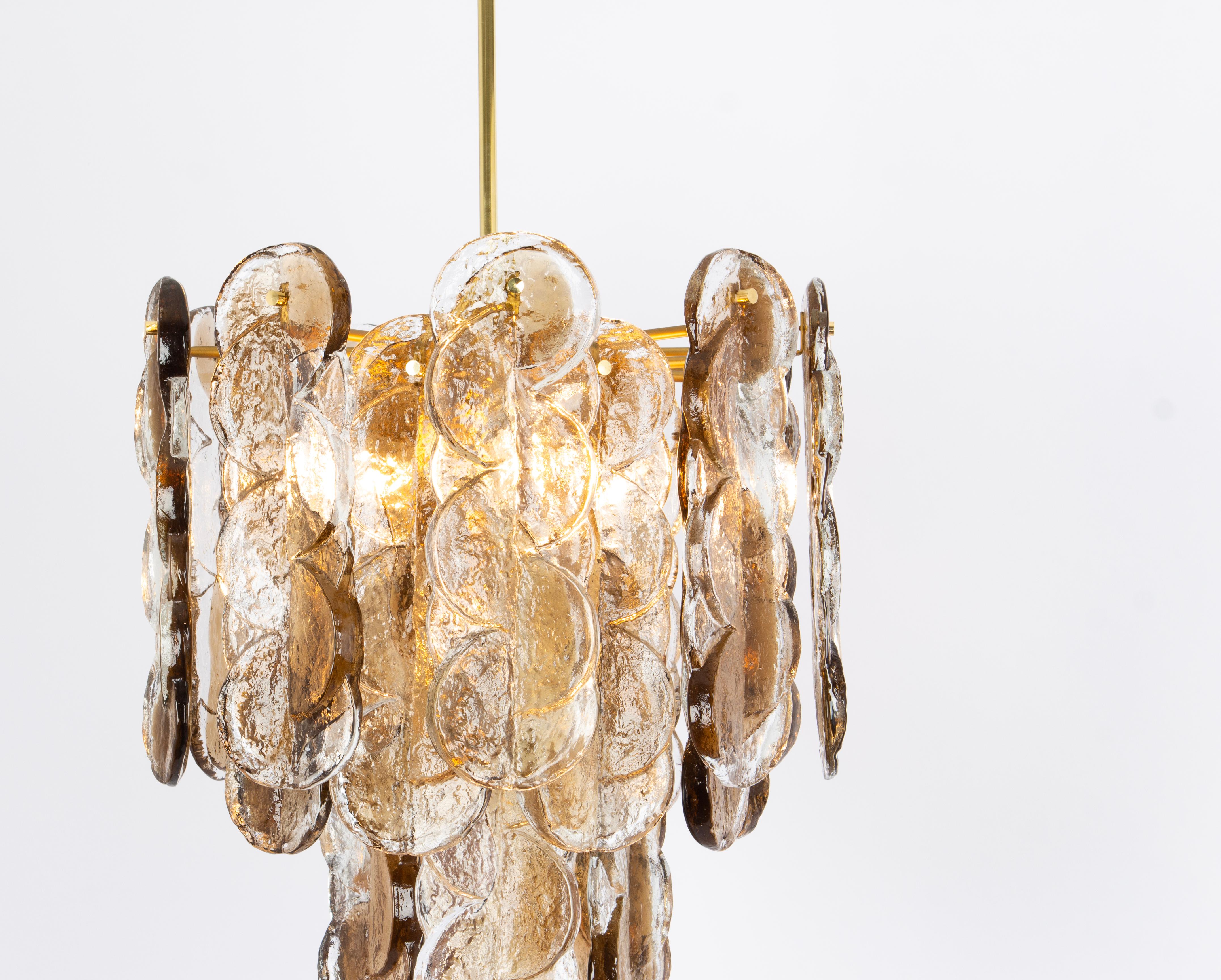 Wonderful Murano glass chandelier by Kalmar, 1970s
Smoked swirl ice glass, clear twisted crystal glass panels with a light goldish amber colored stripe in it.

It needs 6 x E27 standard bulbs.
Light bulbs are not included. It is possible to install