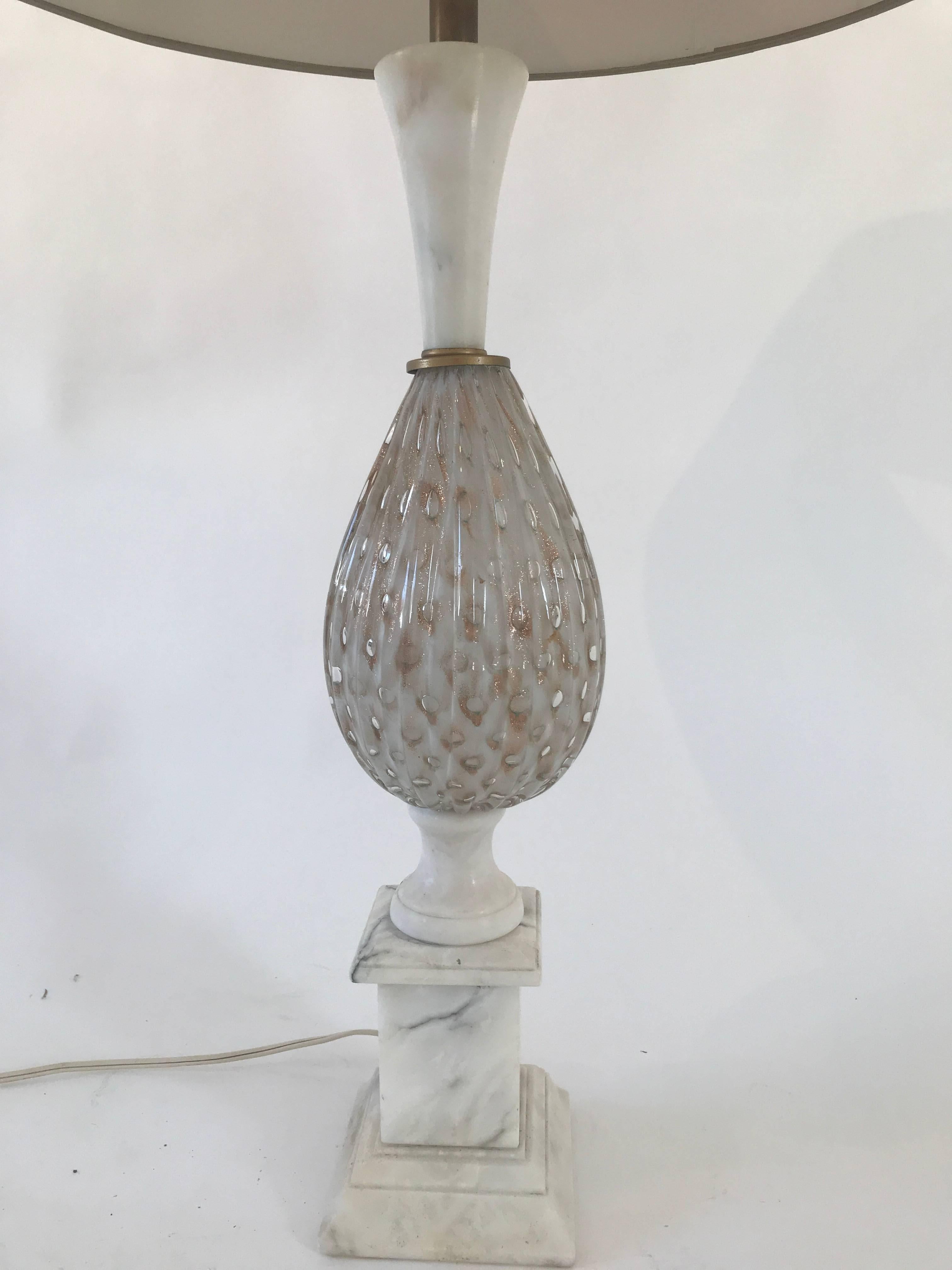 Beautiful 1960s Murano glass lamp in a pink color with gold inclusions, mounted on a marble base. Custom shade subtly echoes the flecks of gold. Very good condition.