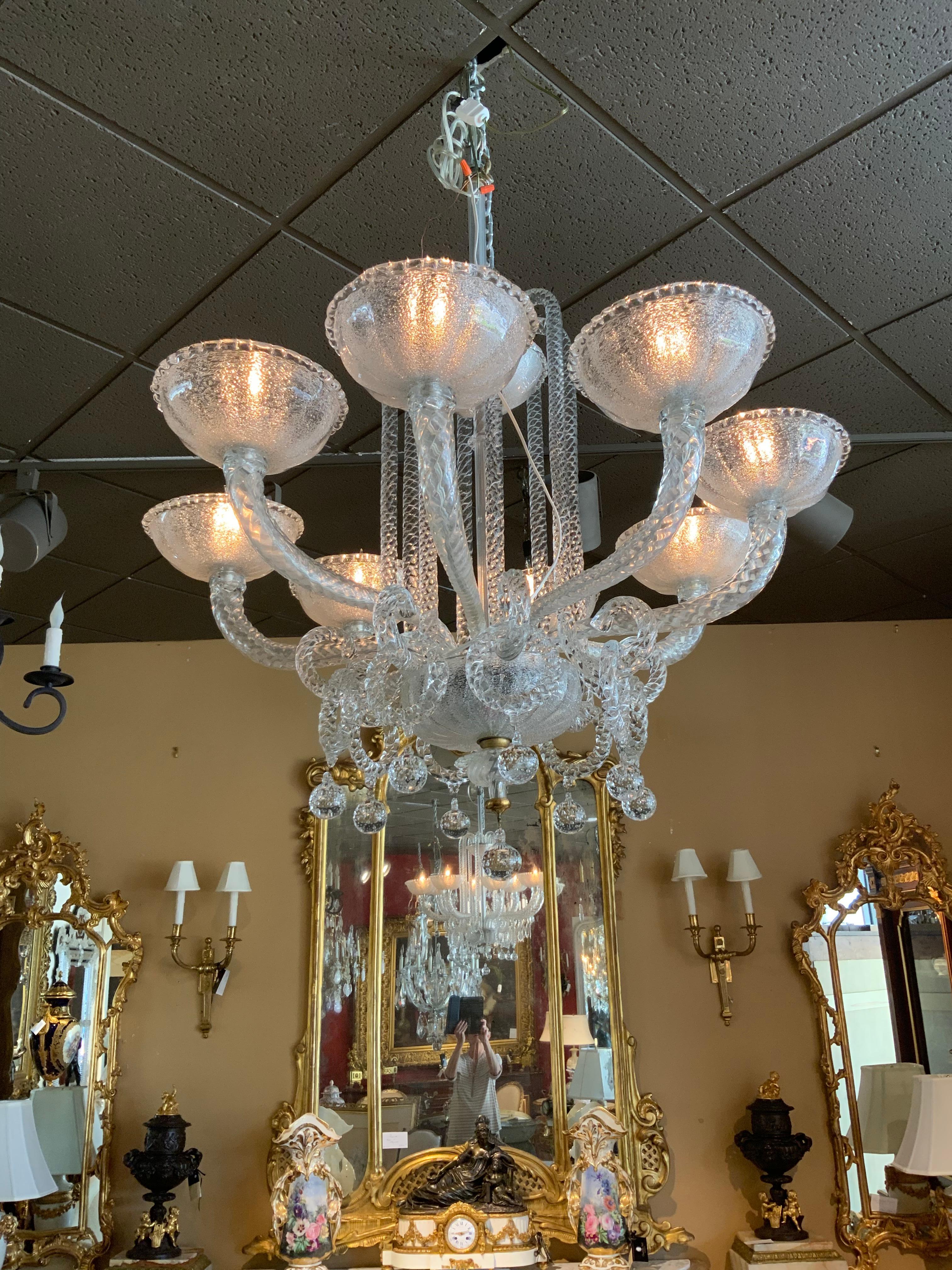 This amazing chandelier is a Murano chandelier with eight bobeches
That are Murano glass. It has a glass standard with eight arms which
Curve gracefully upward. glass rings with glass balls add depth to this
Incredible design. The glass is in a