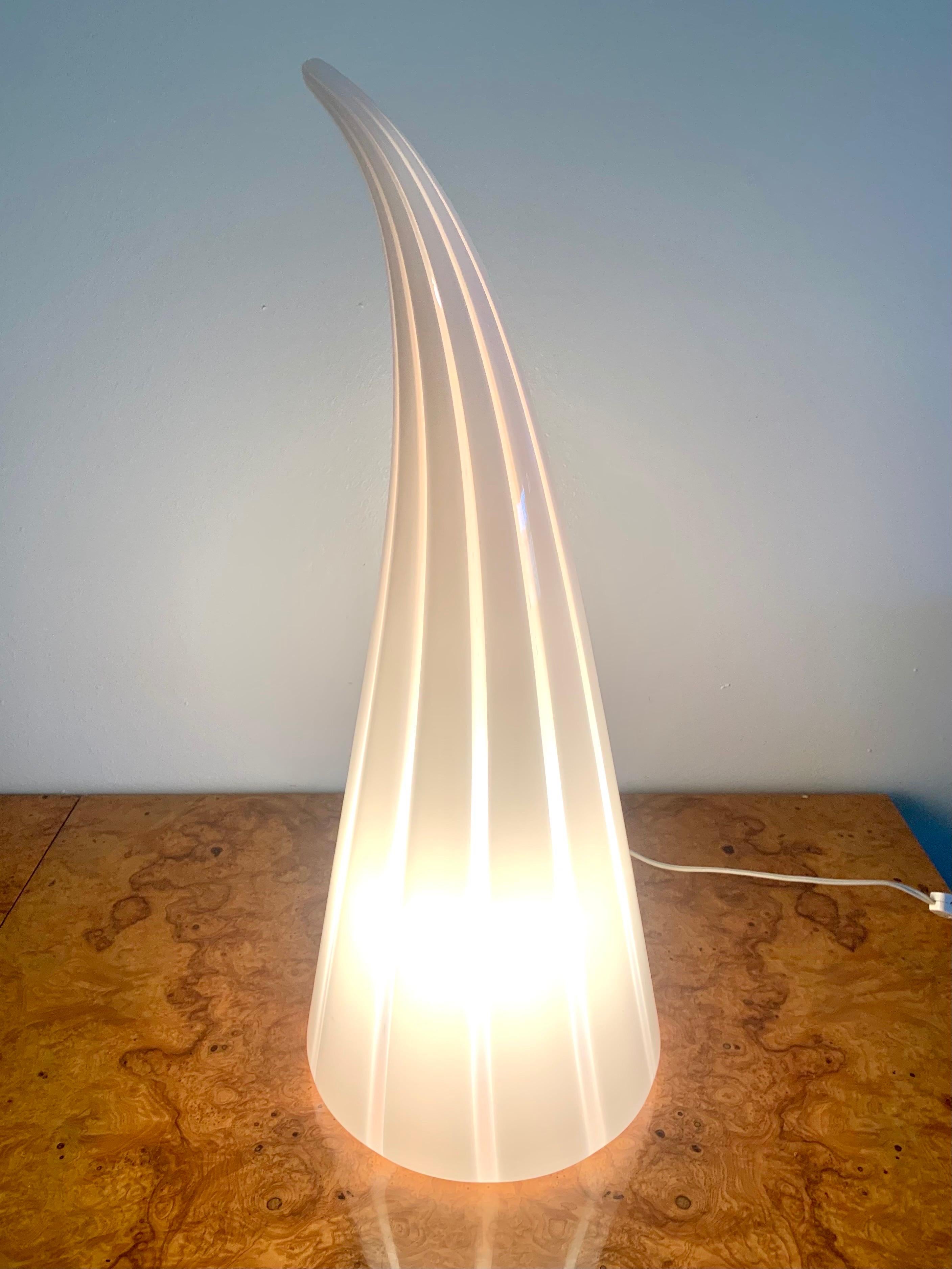 A stunning large striped and slightly swirled glass lamp. Unsure of exact studio but believed to be Vetri or Venini. Large scale horn design of white and clear Murano glass. Can be used as a table or floor lamp. In excellent working condition.