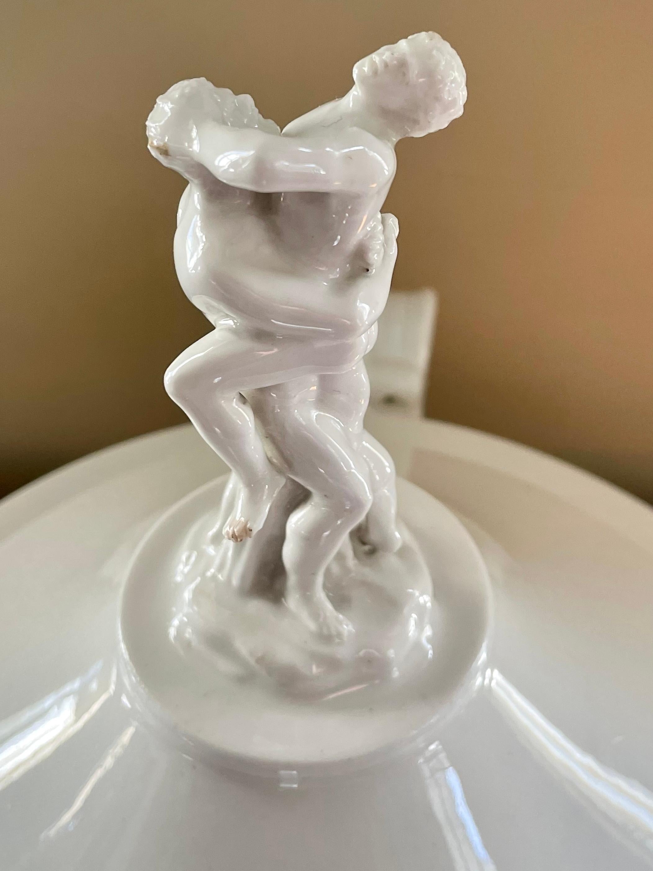Large Naples white porcelain Hercules tureen. Impressive and important neoclassical Ferdinando IV porcelain soup tureen with large Hercules and Theiodamas finial caping a scroll volute handled bowl worthy of the Longhena's Salute in Venice. All on