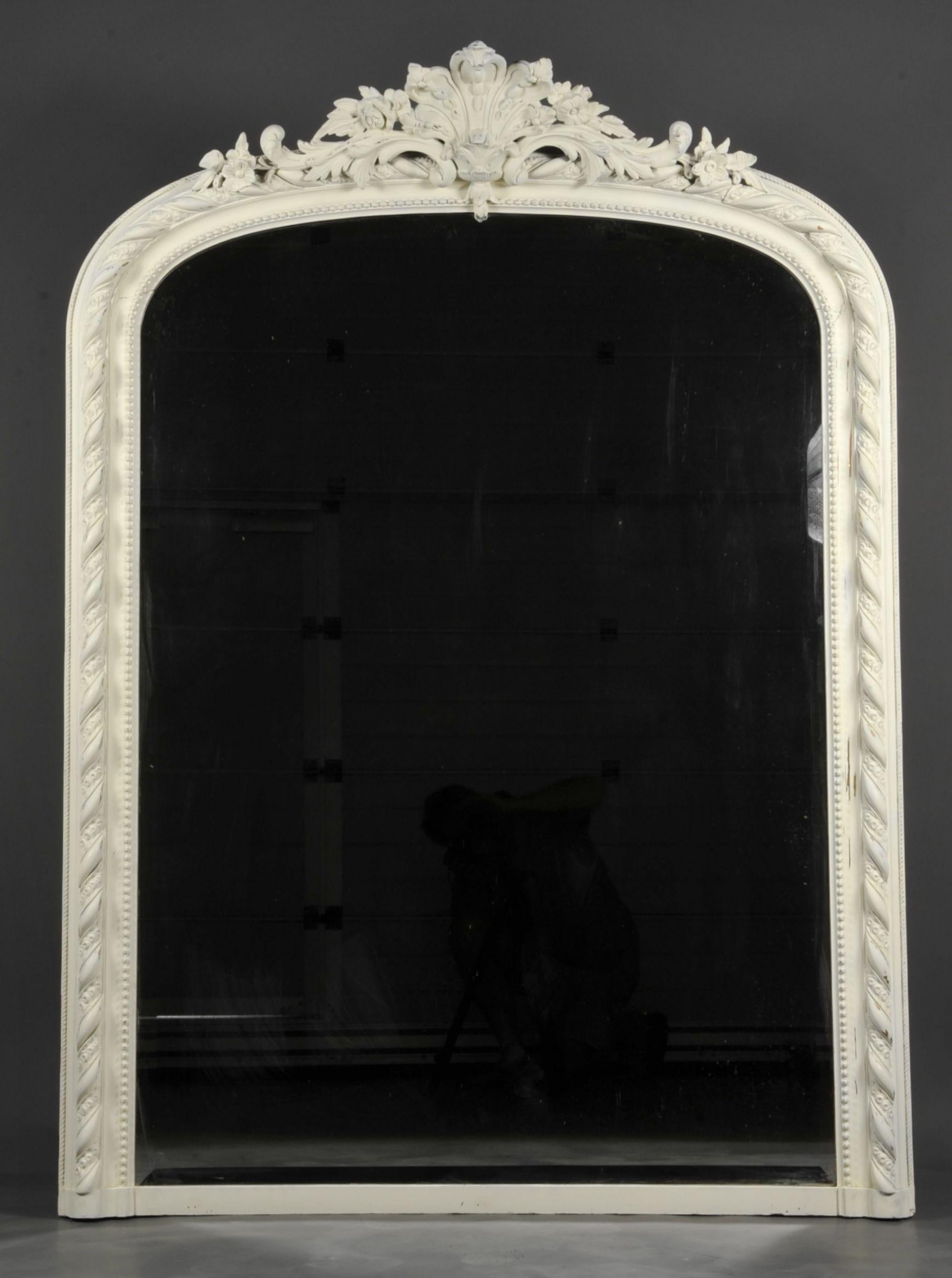 Large Napoleon III Period Mirror In Off-white lacquered wood and stucco with a rich decor of beaded friezes, gadroons and interlacing, surmounted by a large pediment decorated with scrolls and floral patterns

The mirror is beveled and in very