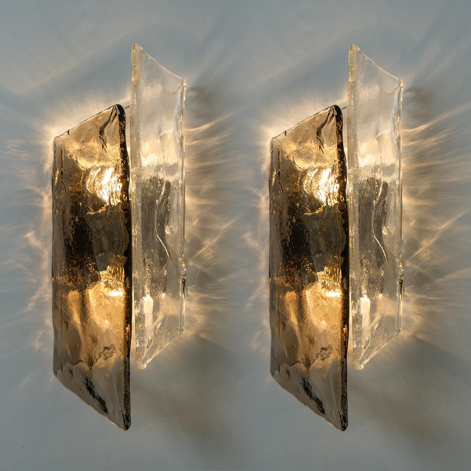 Beautiful and large Murano glass wall sconces or lights by Carlo Nason, Austria, 1970s. A white lacquered metal backplate holds and hand blown and smoked bubble glass shades. Each wall light takes two small base bulbs up to max. 40W per