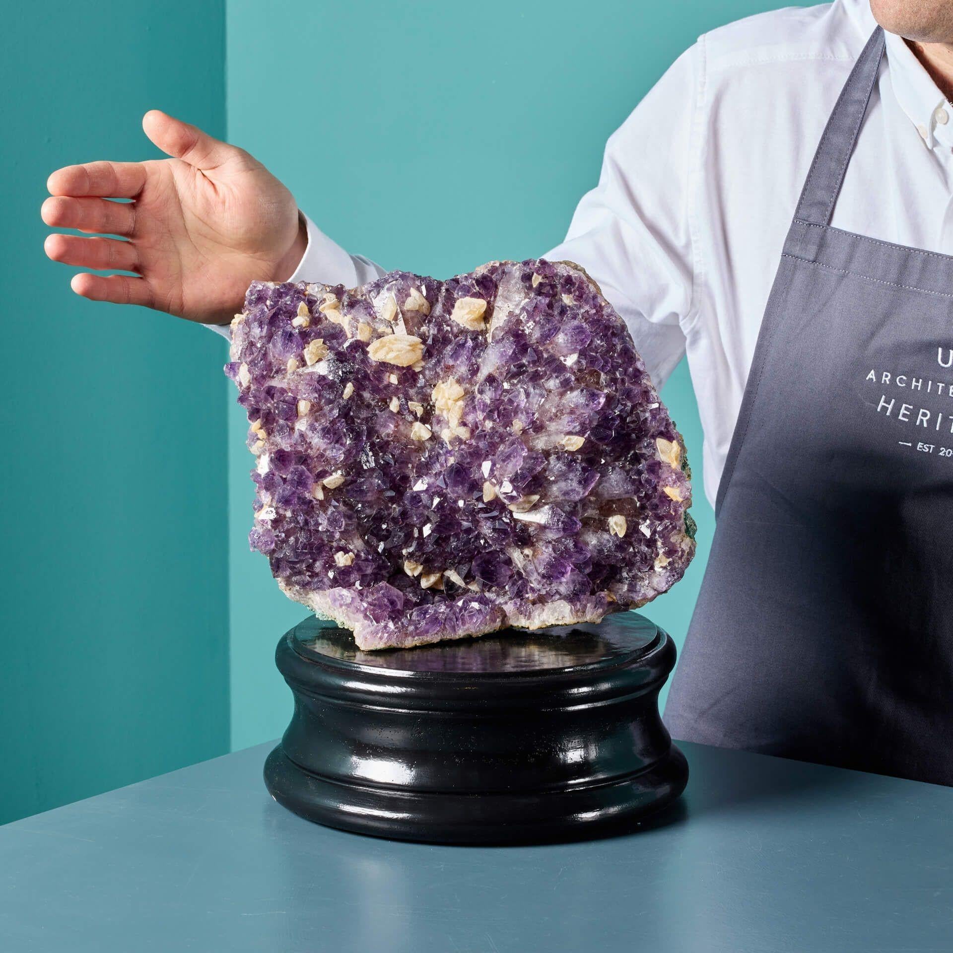 A large scale natural amethyst specimen originating from Brazil. Crystals from Brazil are most often found as radiating masses, with individual crystals appearing as pyramids. This exceptional mineral has a striking plate like form that has been