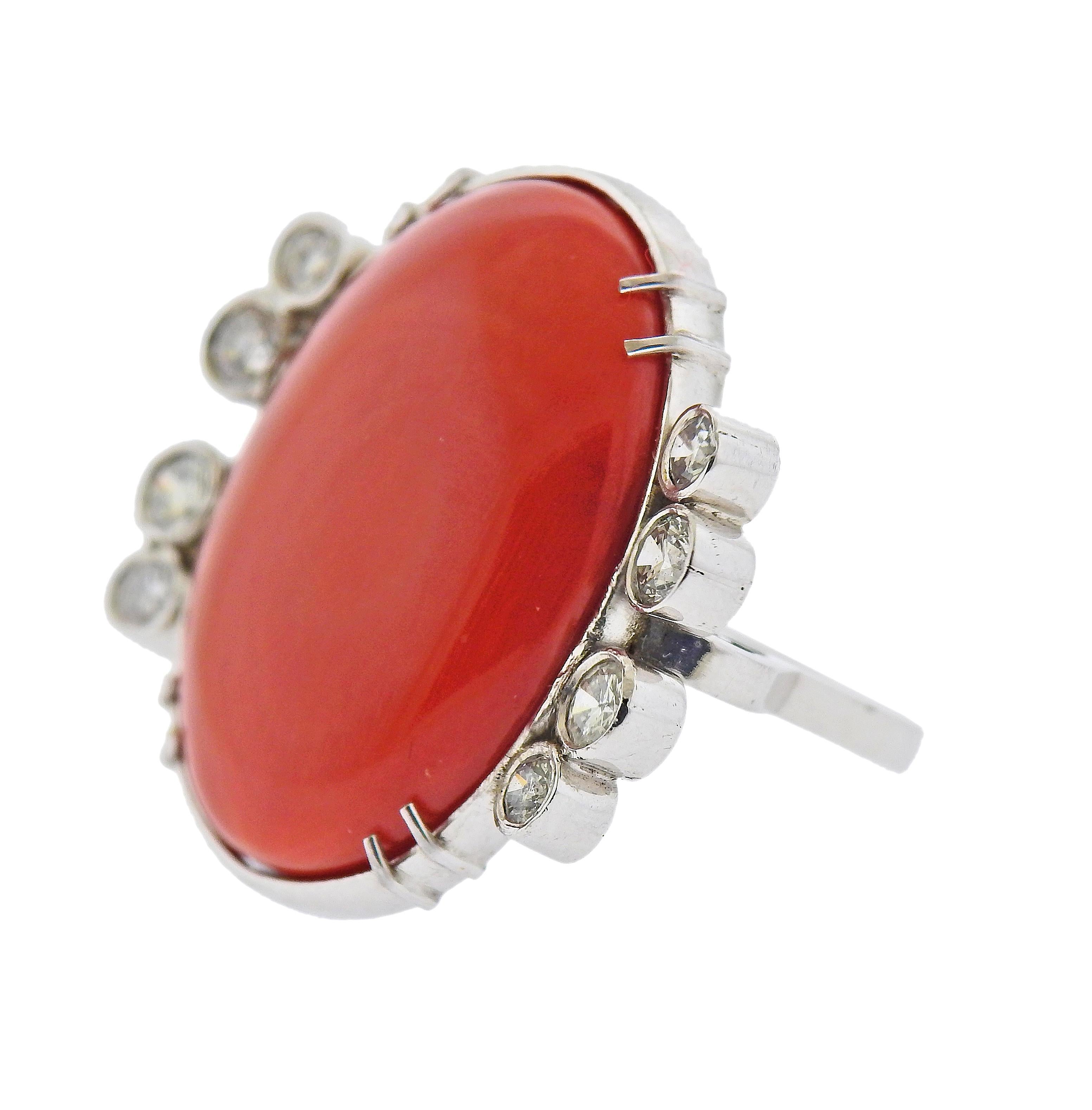 Large 14k gold cocktail ring, with natural oval coral - 26 x 20 x 7.4mm, surrounded with approx. 0.80ctw in diamonds. Ring size - 7, ring top - 28mm x 29mm. Tested 14k. Weight - 14 grams. 