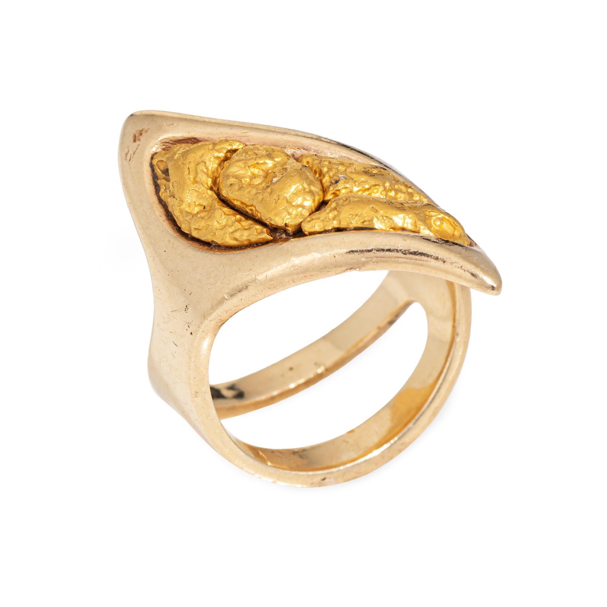 Stylish contemporary nugget ring crafted in 14 karat yellow gold, set with natural gold nuggets. 

Four large natural gold nuggets adorn the unique undulating mount. The gold nuggets test between 22 to 24k gold with a bright buttery sheen. Weighing