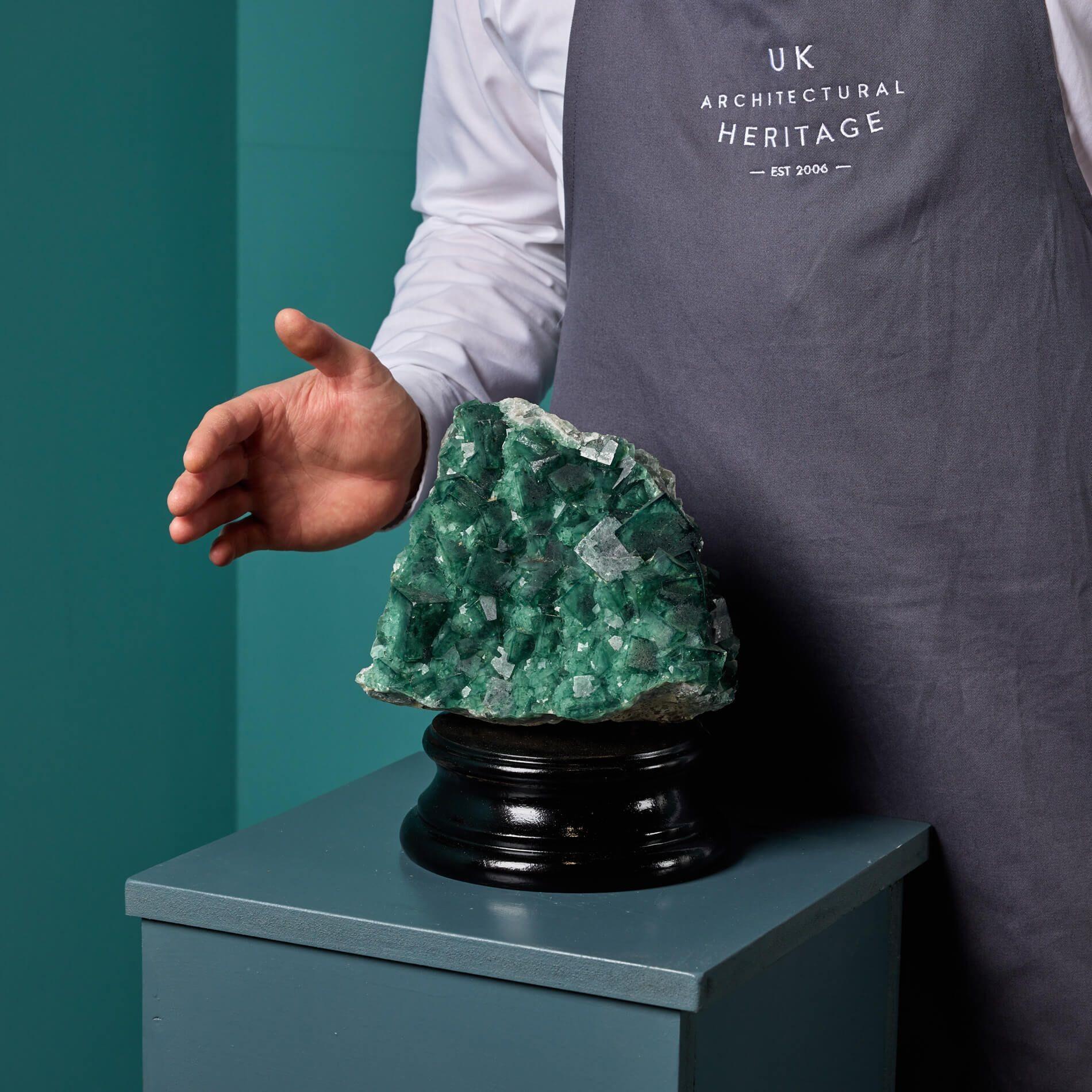 A striking large natural Madagascan green fluorite specimen sourced from an ex UK collection.

This fluorite specimen is of an impressive scale and unusual irregular shape with large cube crystals displayed on a custom neoclassical style