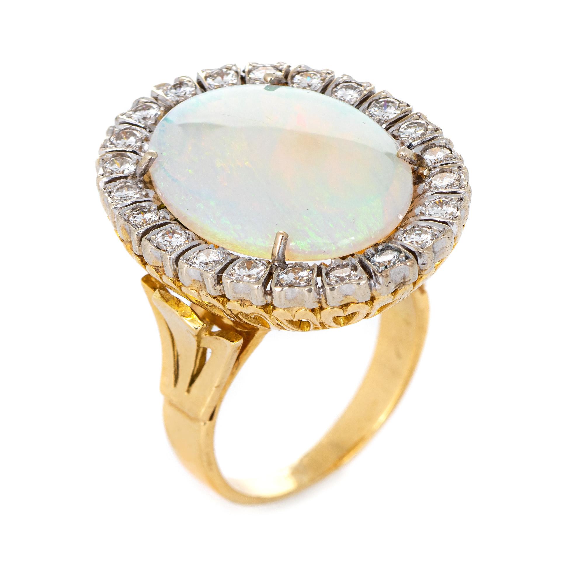 Stylish vintage opal & diamond cocktail ring (circa 1970s to 1980s) crafted in 18 karat yellow gold. 

Natural opal measures 20mm x 15mm (estimated at 21 carats), accented with 21 estimated 0.07 carat round brilliant cut diamonds. The total diamond
