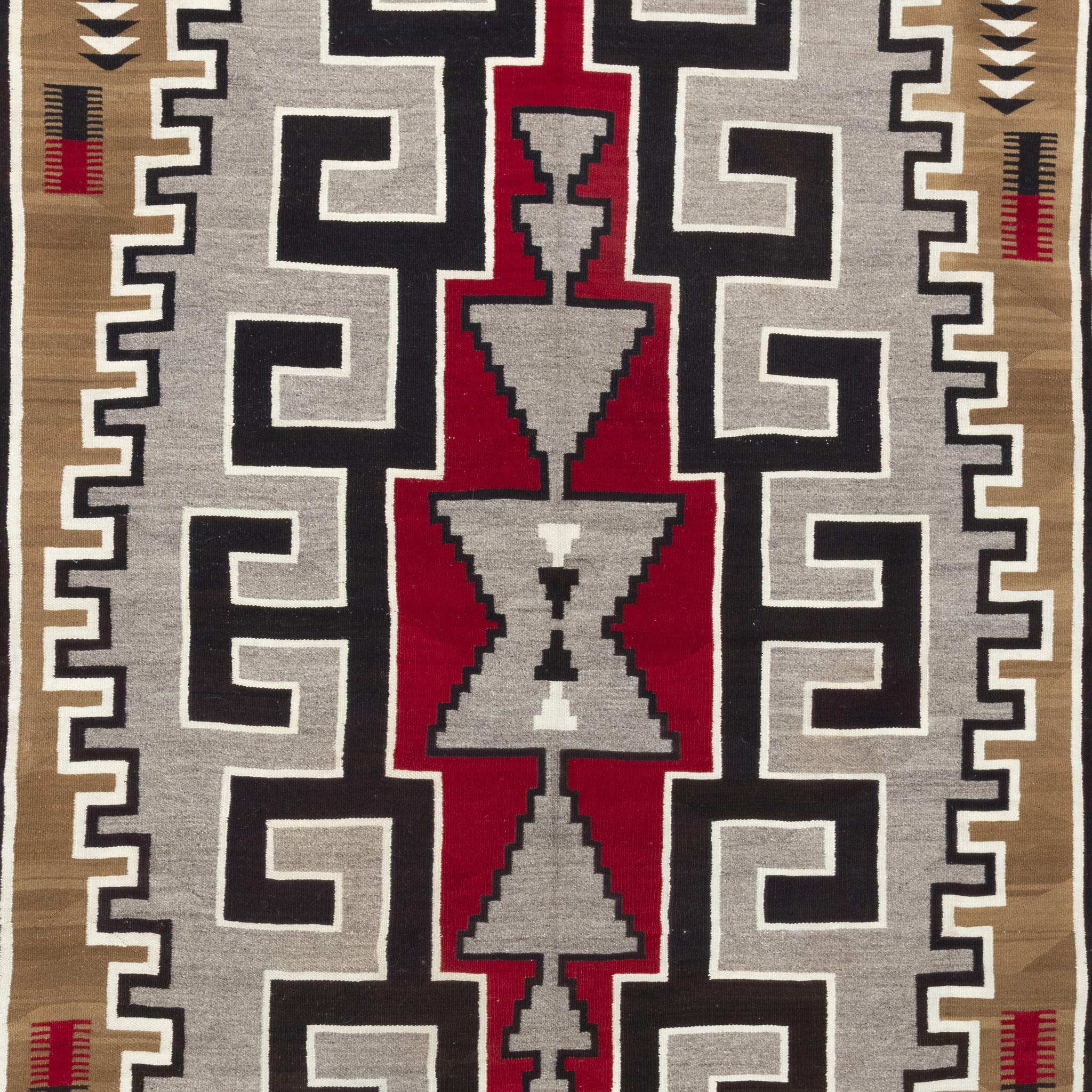 Navajo Klagetoh area weaving. Exceptional piece with a tight weave and striking colors of black, red, brown, grey and white and large signature central design. Early 20th century. Size:  8'1