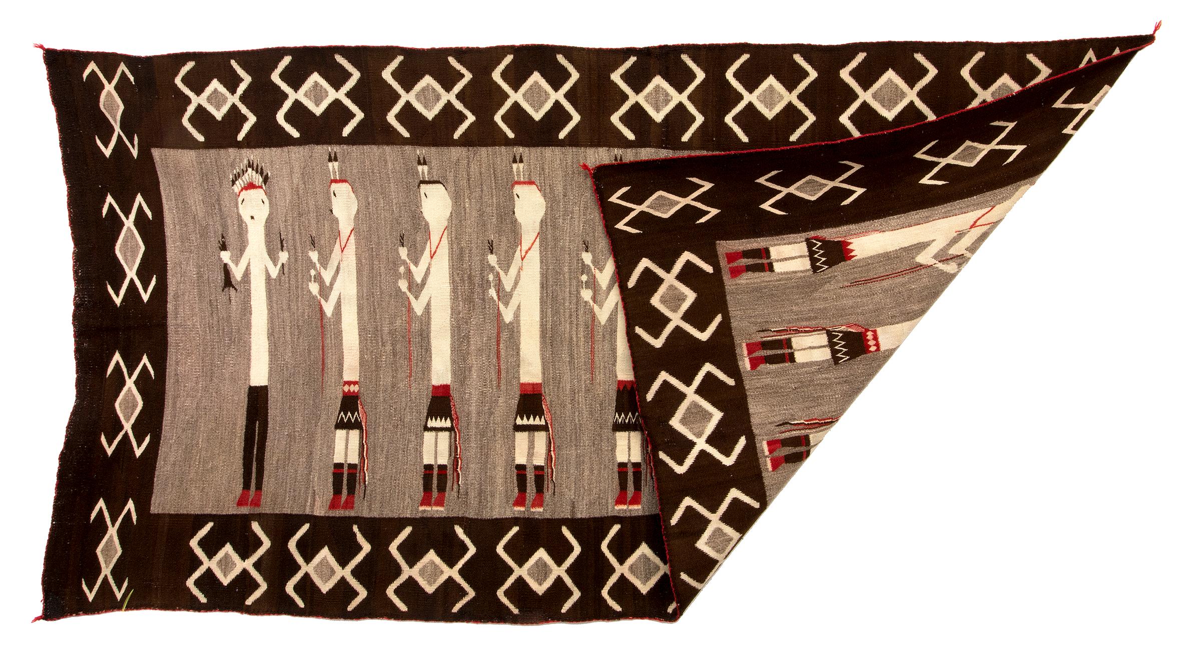 Large vintage Navajo Rug, Pictorial Weaving, circa 1930s with nine Yei or Yeibichai figures wearing traditional dress including kilts and feather headdresses with water bug motifs around the border. Woven of native hand spun wool in natural fleece