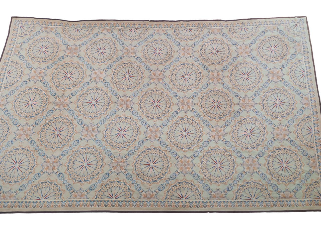 Large needle point rug 670x 430 cm. with continuous pattern from the '80s. 
Vintage France Style, handmade in China in the '80s. Large size, measuring 6.70 m x 4.30 m, featuring various shades of blue, beige, and a touch of deep brown. The