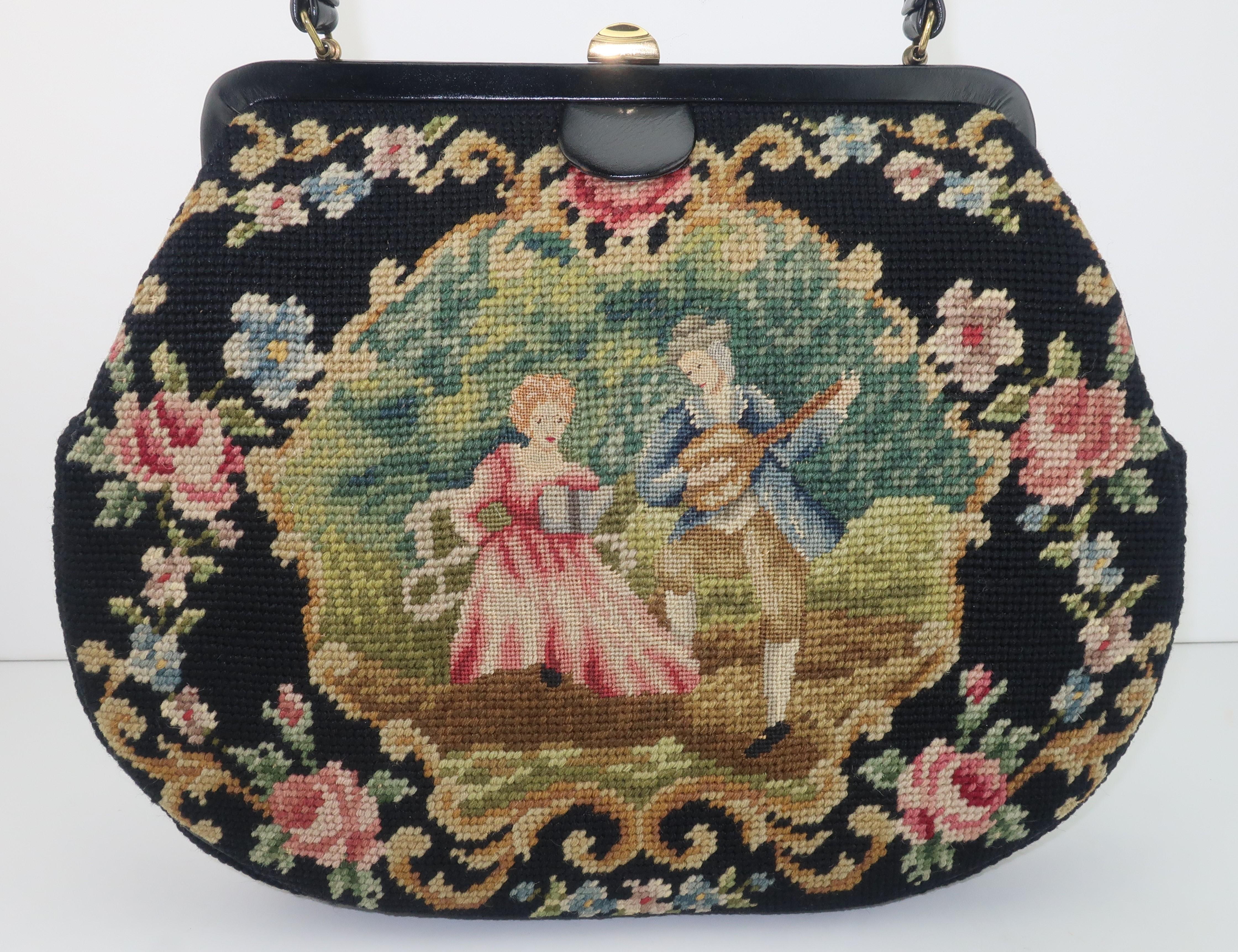 Not all 'granny bags' are created equal!  This 1950's needlepoint example is at the front of the pack with a black leather frame accented by a country French scene depicting a petit point couple on one side and a floral pattern on the other in