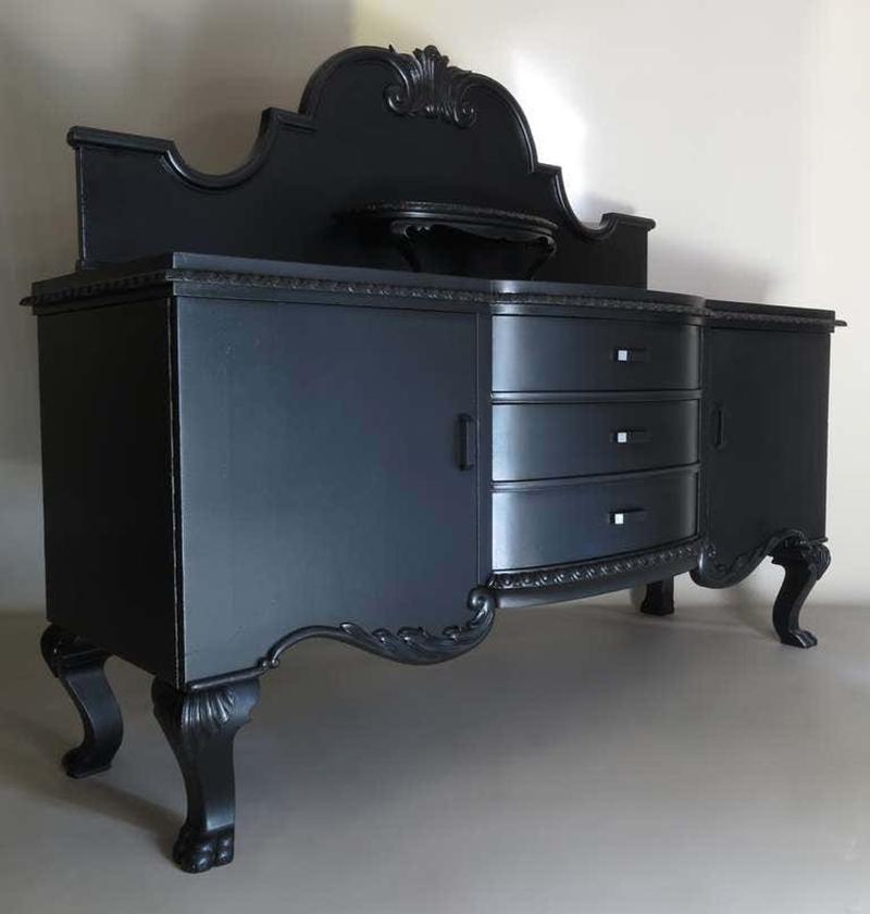 Striking buffet or sideboard of impressive proportions, raised on cabriole legs ending in lions' paws. The round-fronted central drawers are flanked on either side by cupboards containing shelving space.