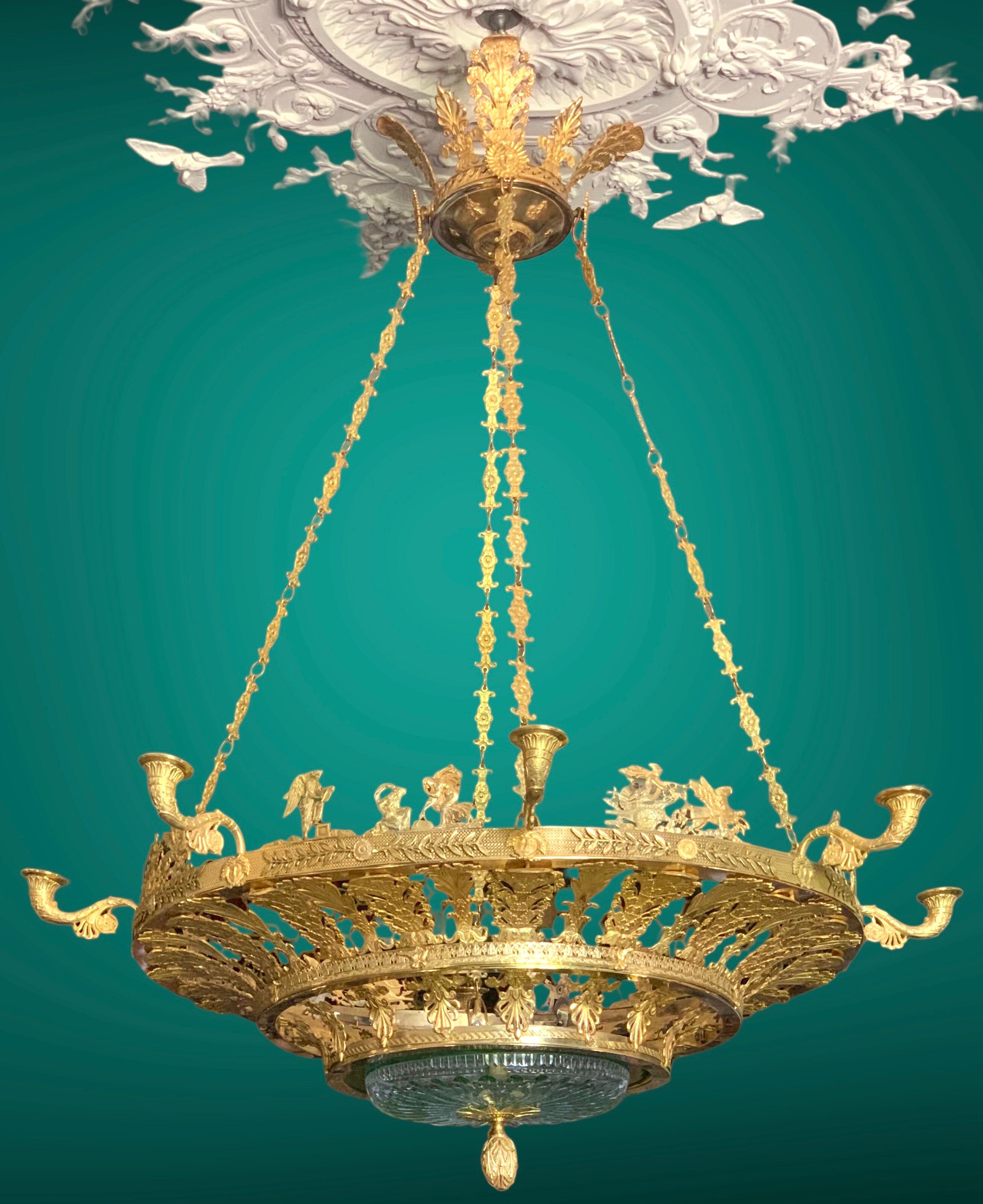 Imposing  Neo-classical chandelier in pure Empire style, with castpalmettes motifs and mythological figures in fine gilded bronze
In the center, a green cut  crystal cup support  a massive bronze seed
8 lights arms  easy to electrify on demand