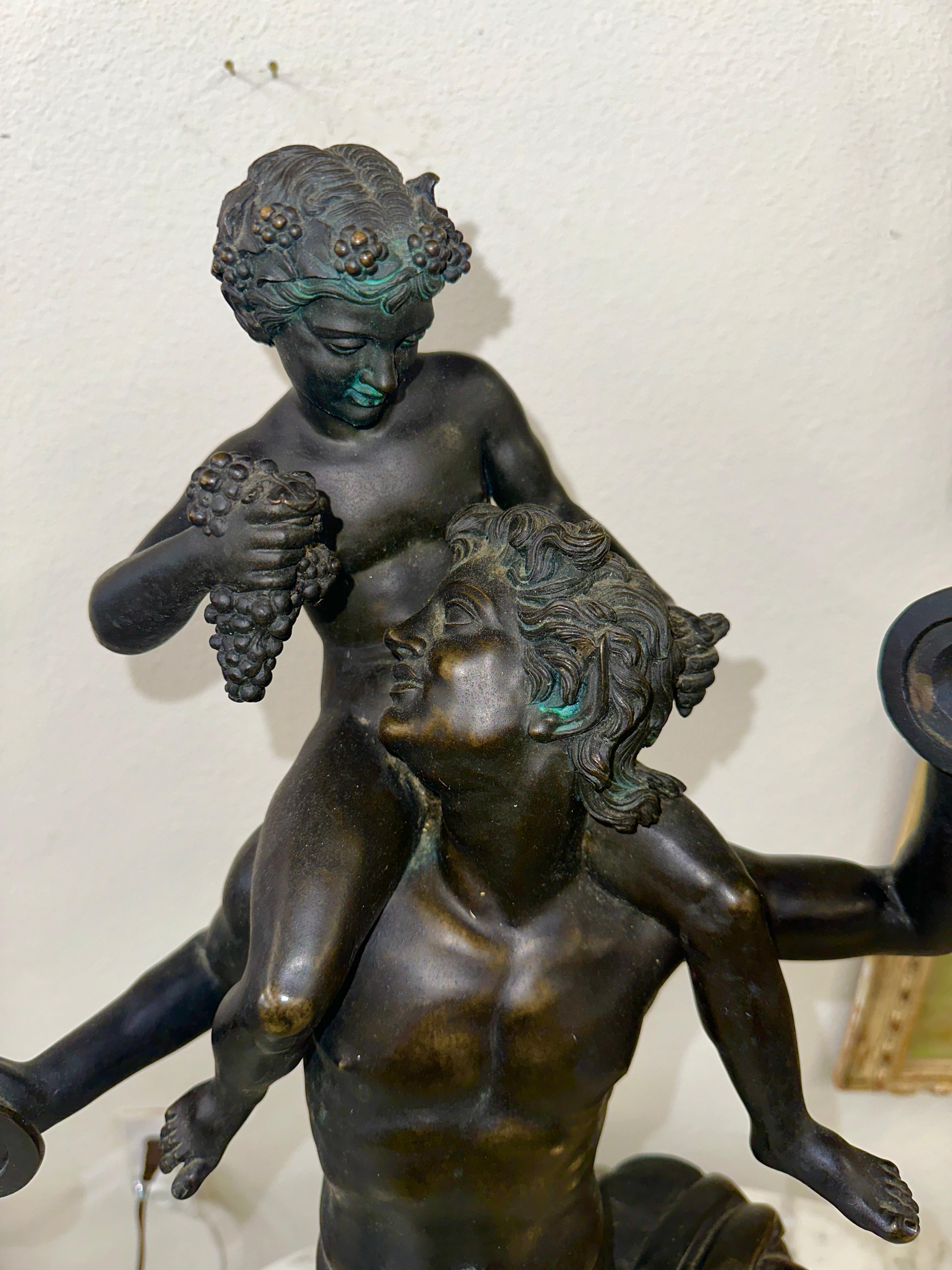 A Large Neo Classical Bronze Grand Tour Sculpture depicting a Faun and Pan perhaps. I’ve seen this described as Satyr and the infant Dionysus. It may be late 19th century but likely early 20th Century from a Neapolitan Foundry, after the antique. In