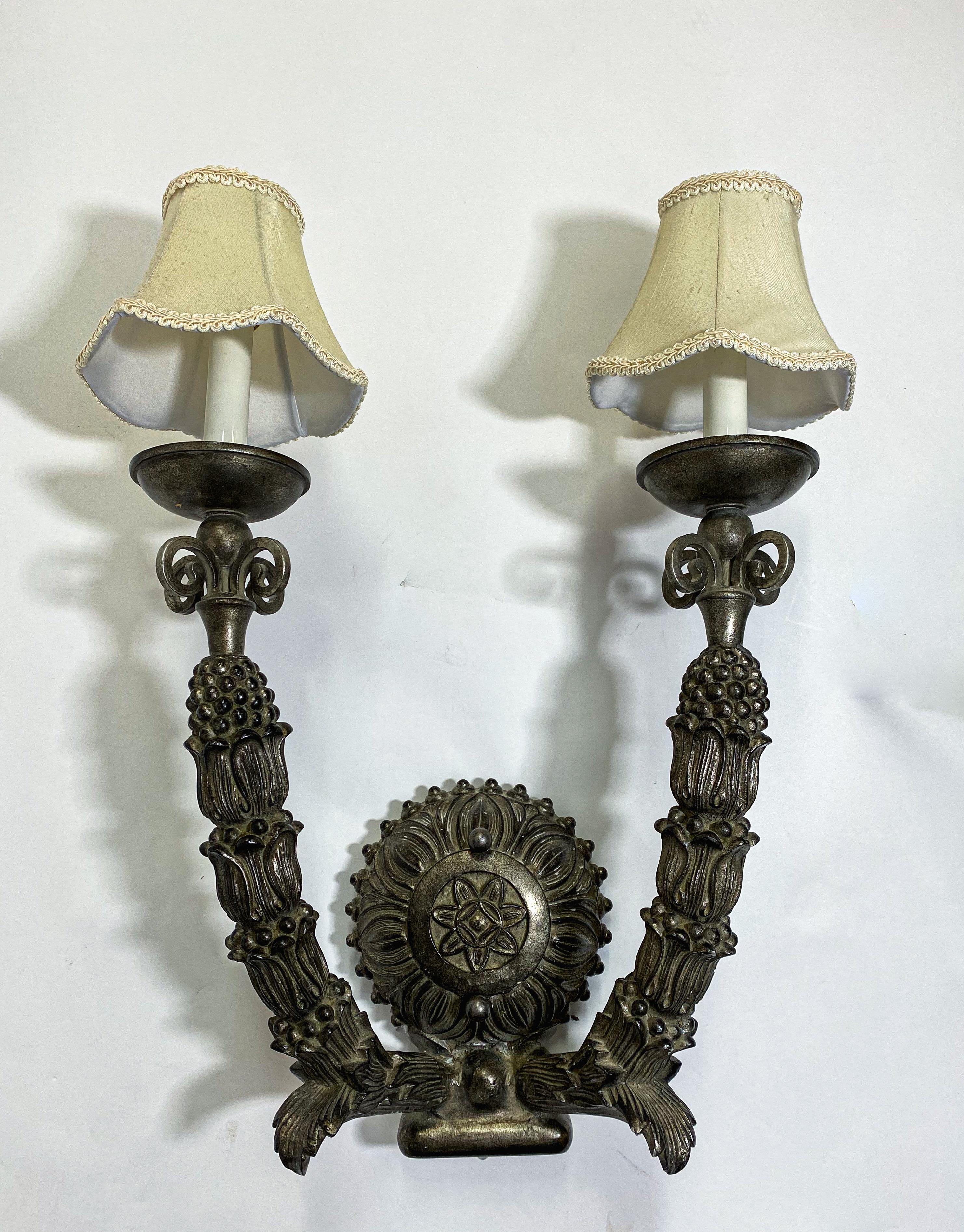 An exceptional Neo Gothic large size wall scone. The wall sconce has two large arms, each arm ending in a candelabra light with a custom made French style shade. The iron cast sconce features beautiful patterns and details. Each arms is finely