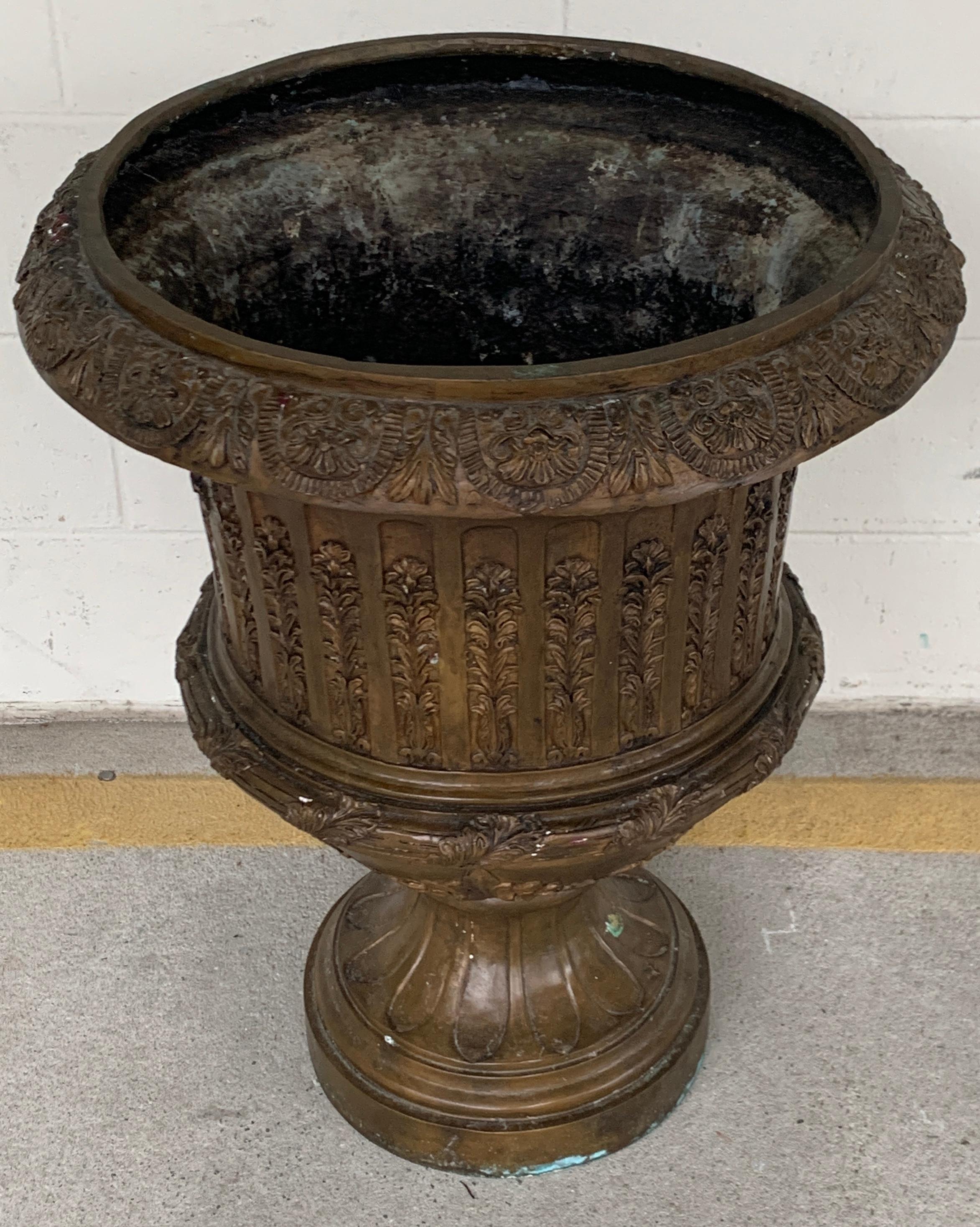 Large Neoclassical Bronze Urn, Of typical form nicely cast with fluted body with all over foliate decoration, raised on a 12