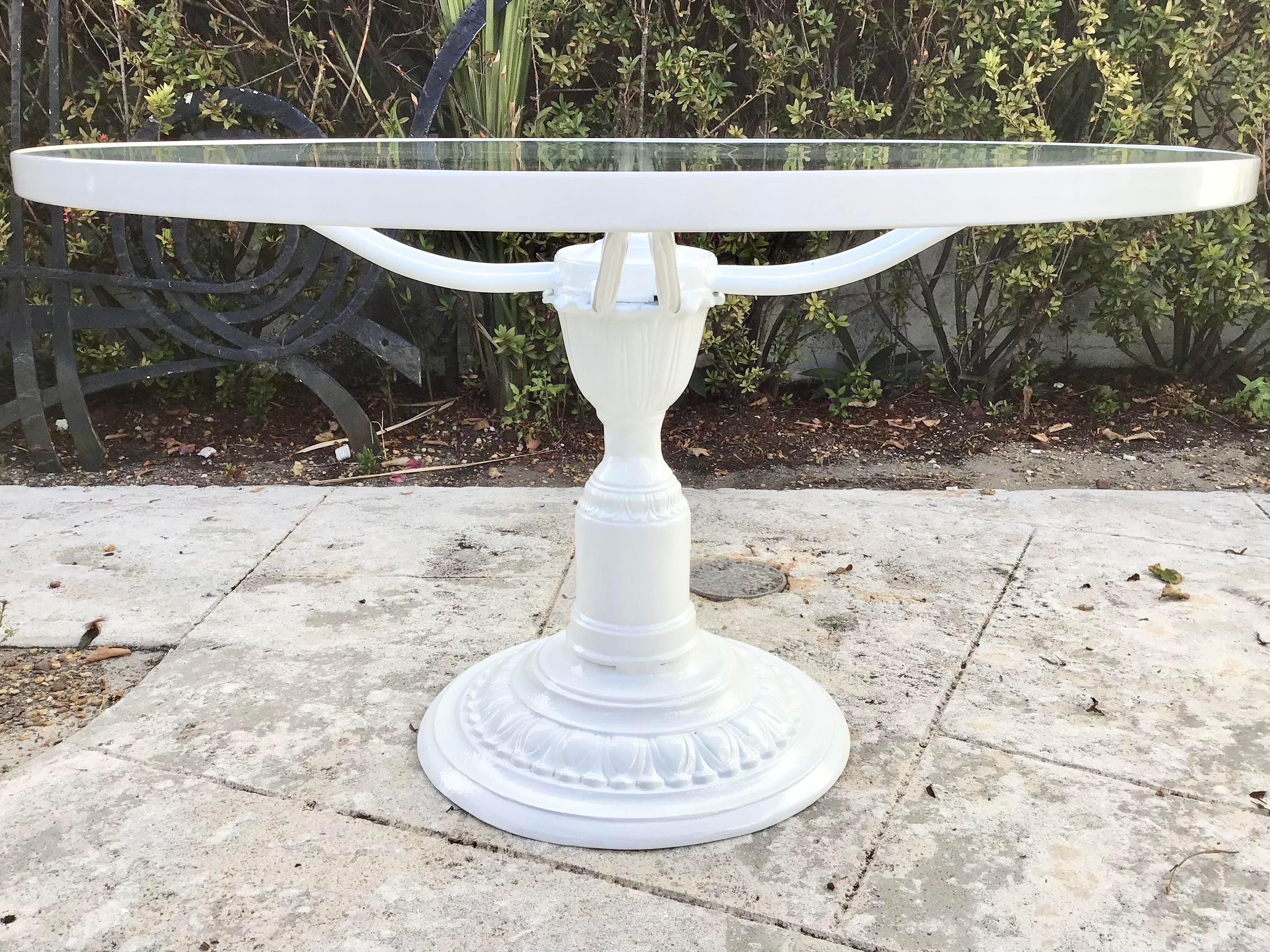 Fabulous large round outdoor table with a glass top on a pedestal. The frame consists of one piece, pedestal is not removable. Freshly lacquered in white. Would be an excellent addition to your patio to entertain several guests. Just add some chic